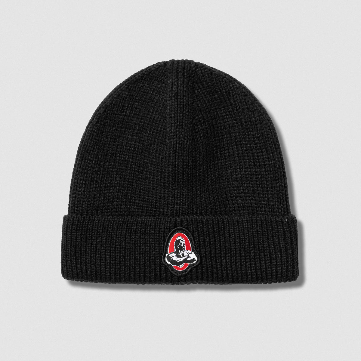 Flat lay of Signature Ribbed Knit Beanie against gray background