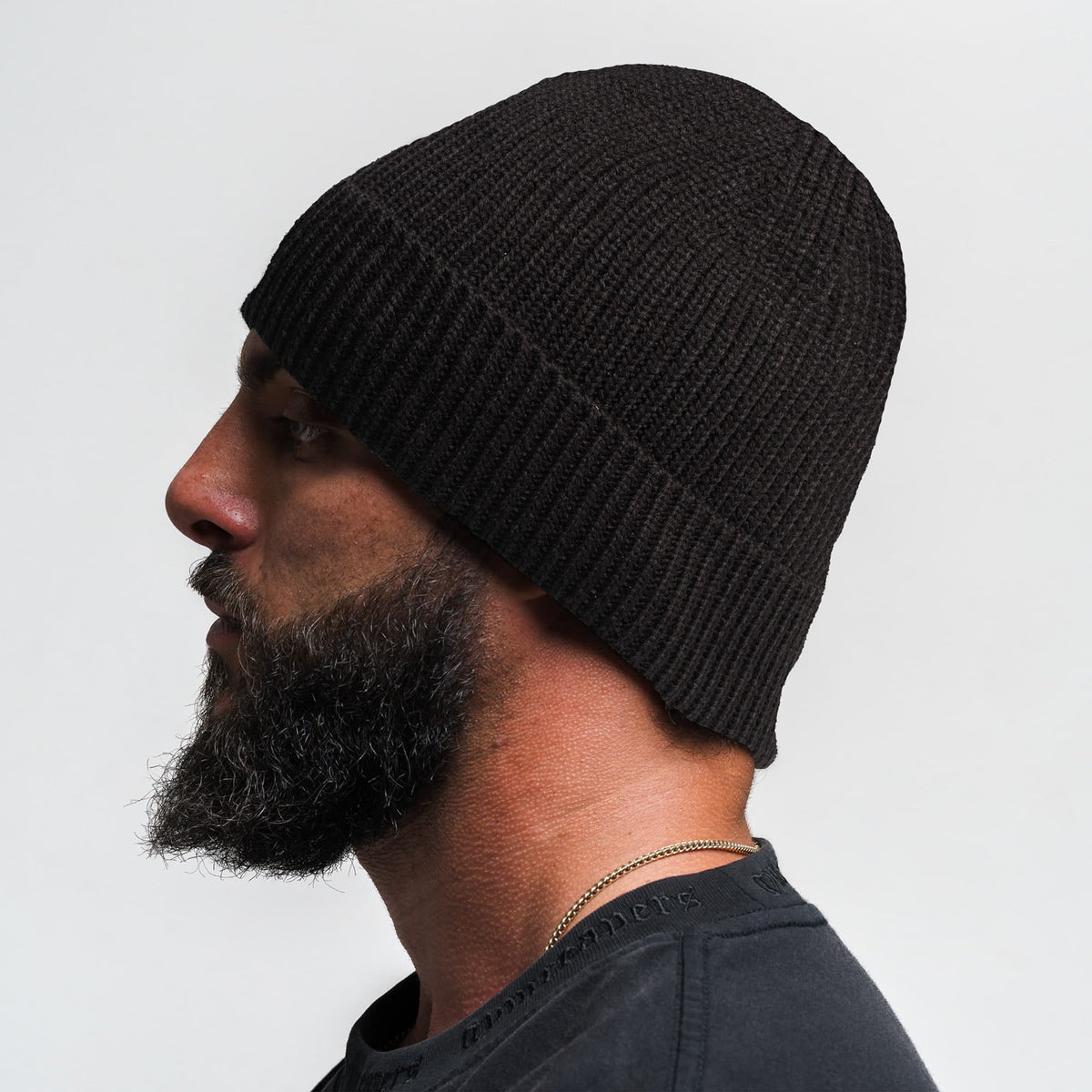 Side view of a model wearing the Signature Ribbed Knit Beanie