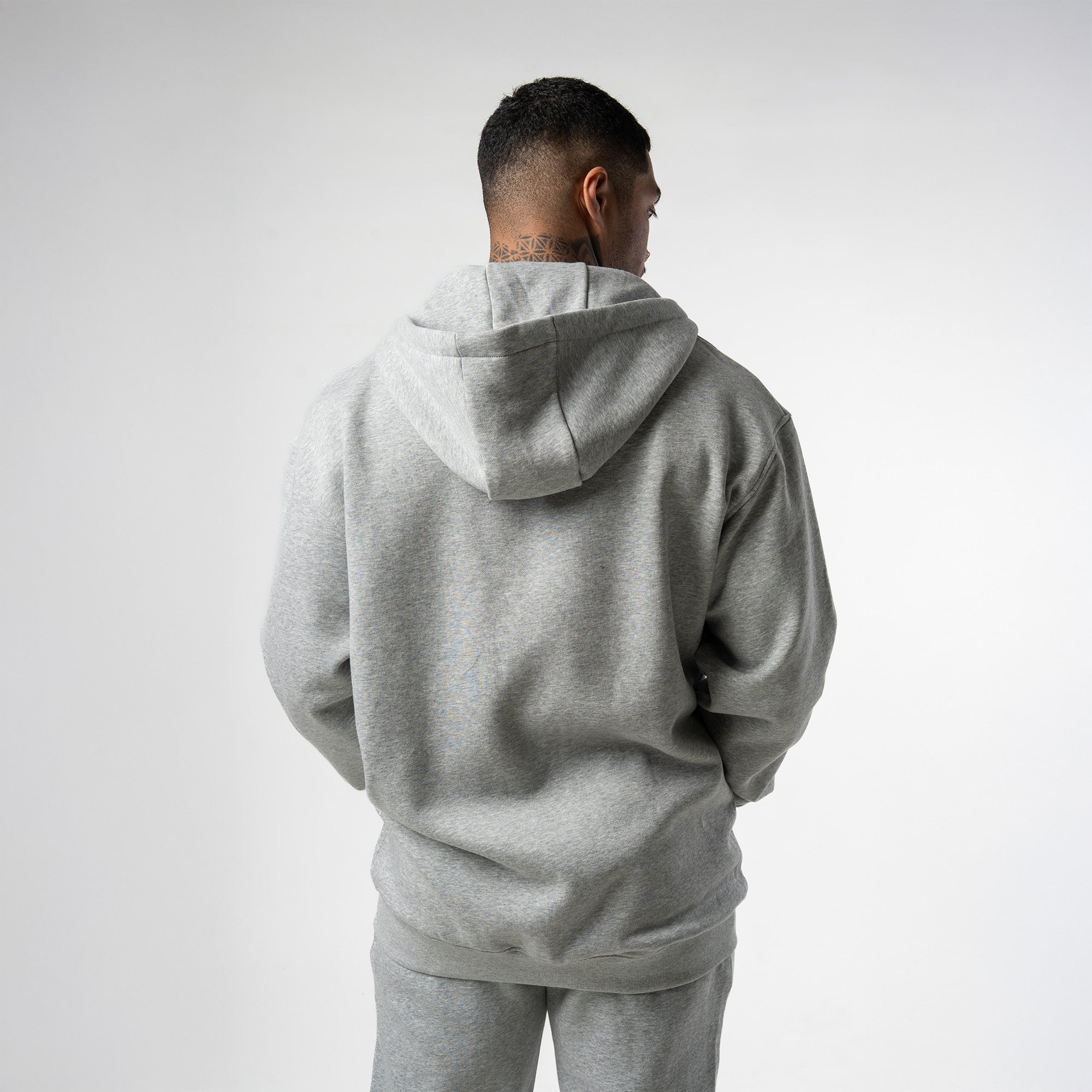 athlete wearing gray axis zip up back view