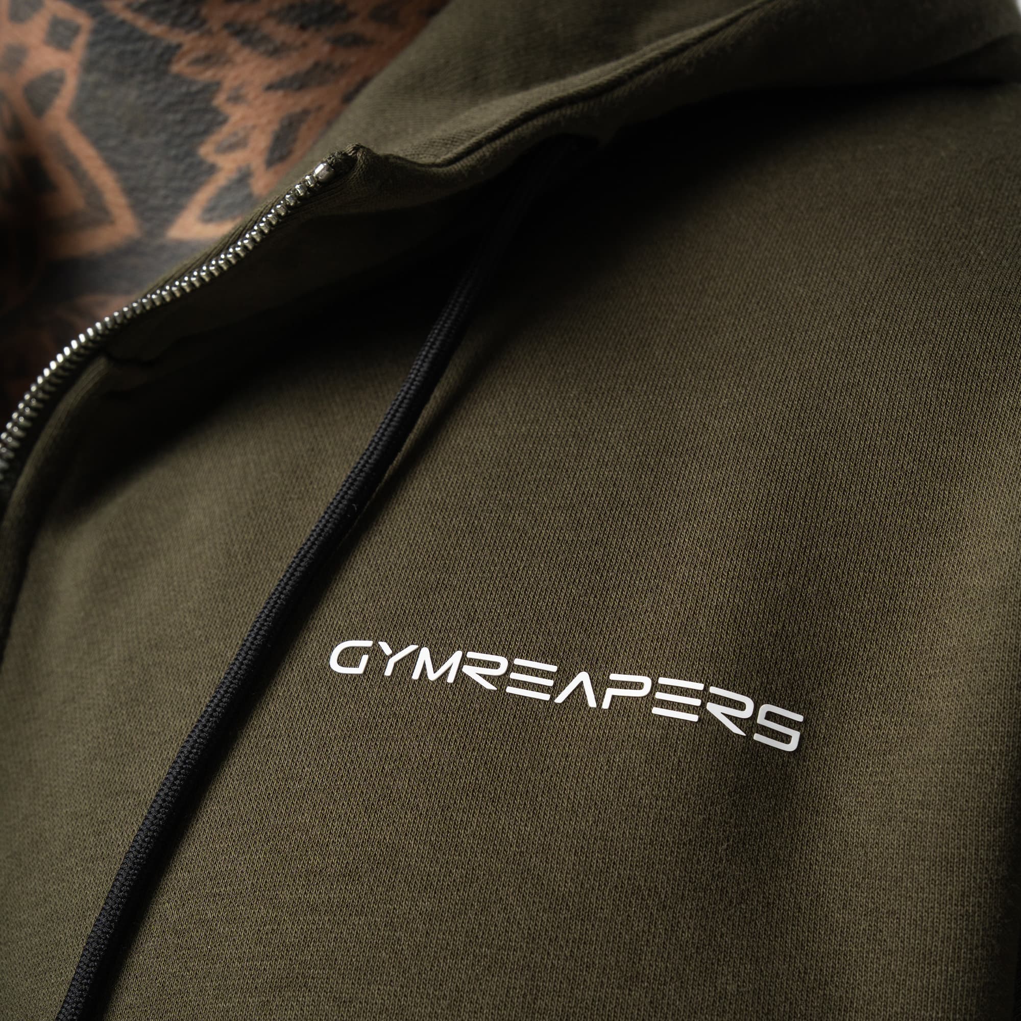 athlete wearing green axis zip up close up detail shot of logo