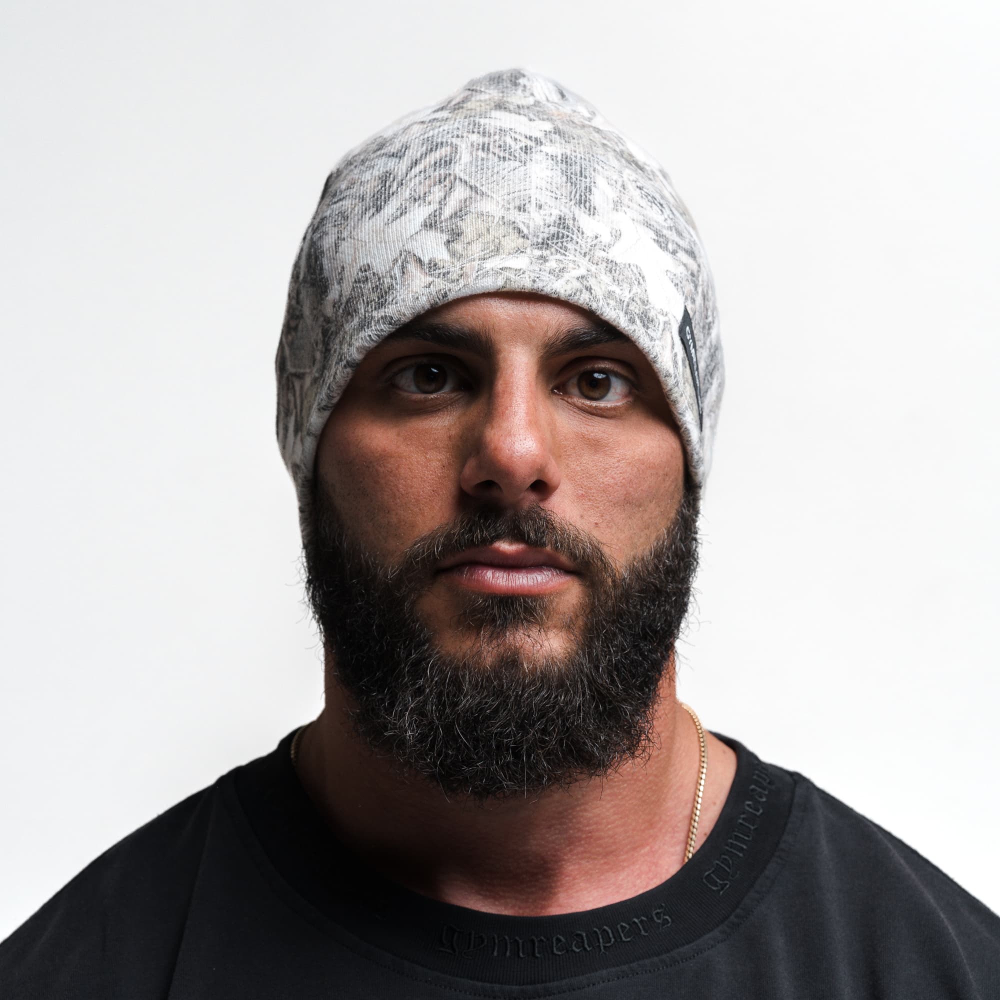 Athlete wearing Skull Cap Beanie - Camo front view