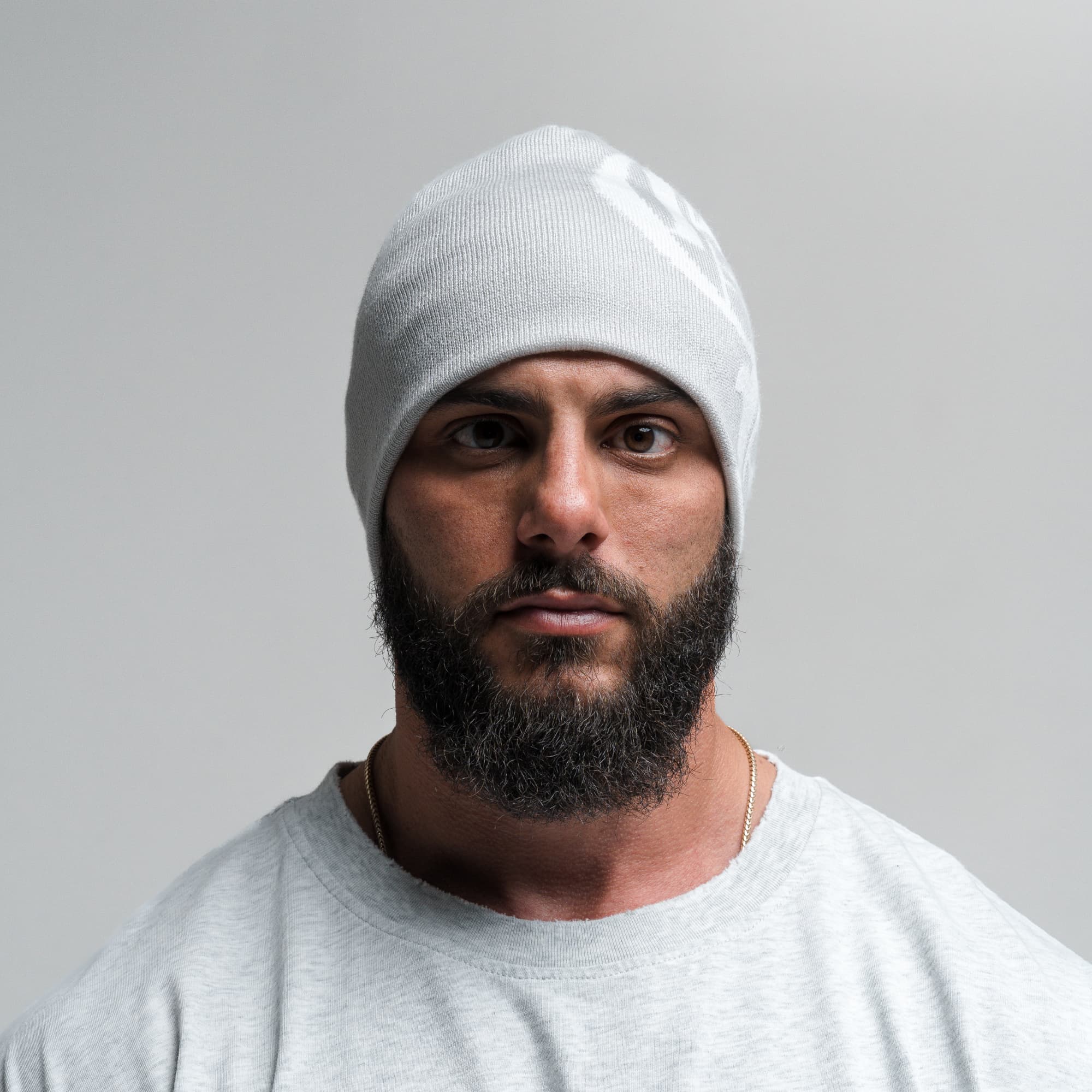 Athlete wearing Initial Skull Cap Beanie - Gray/White front view