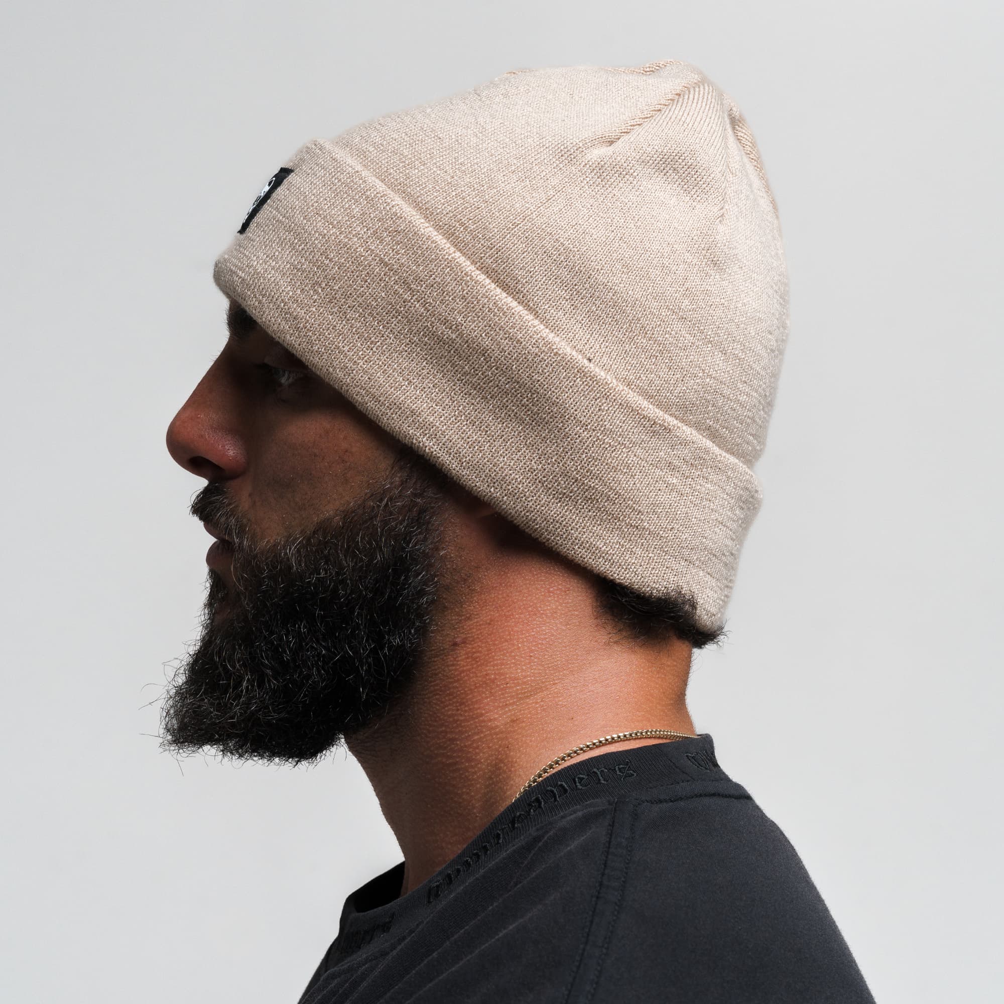 Athlete wearing Skull Knit Cuff Beanie - Tan side view