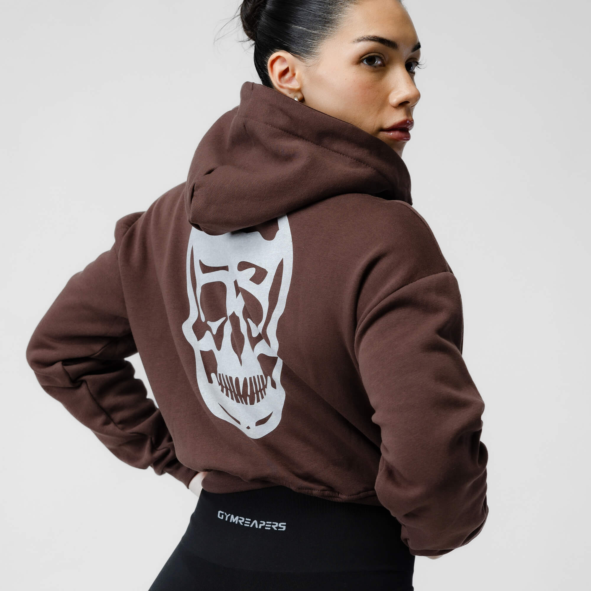 brown cropped hoodie skull logo close up