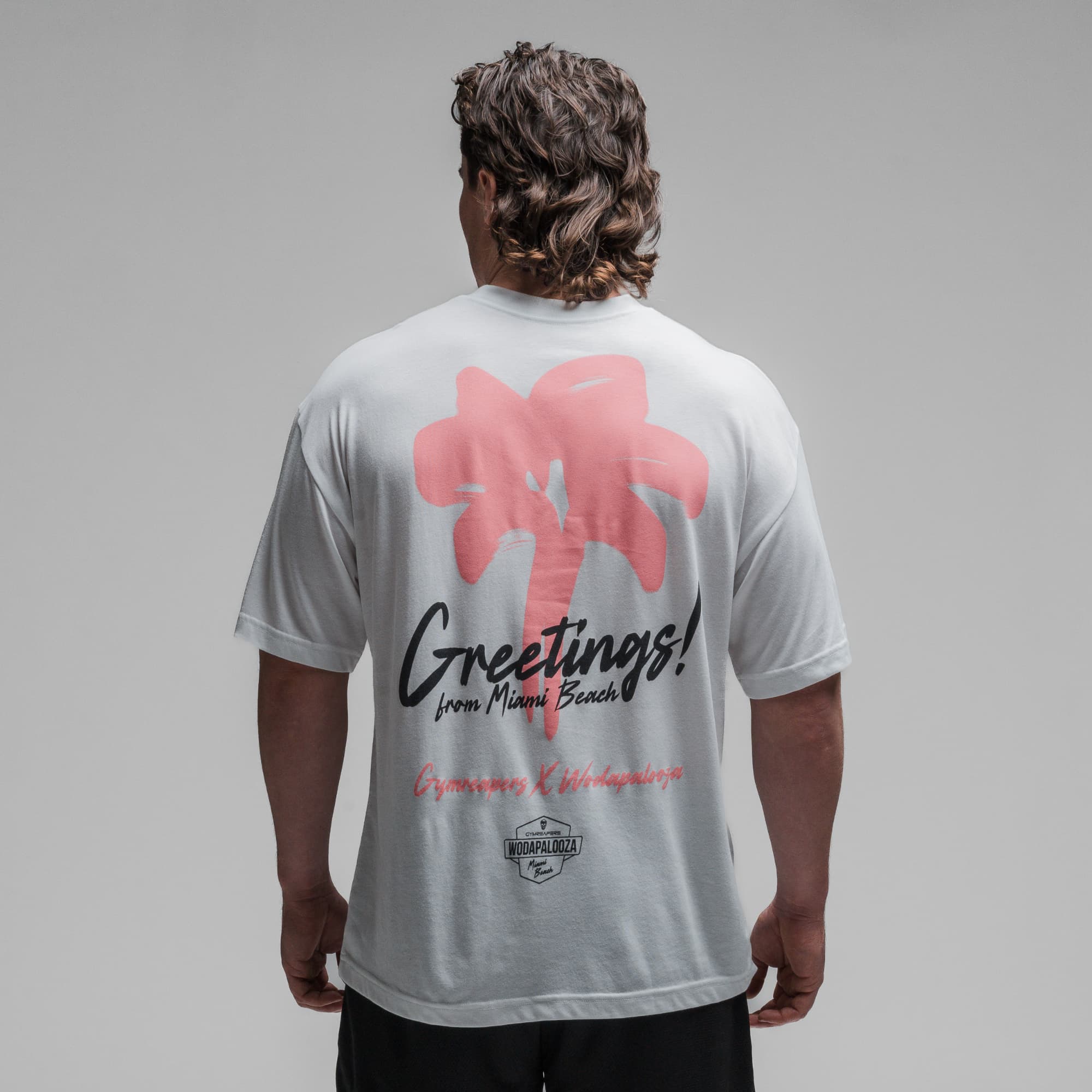 Athlete wearing the Greetings Tee half body shot back side