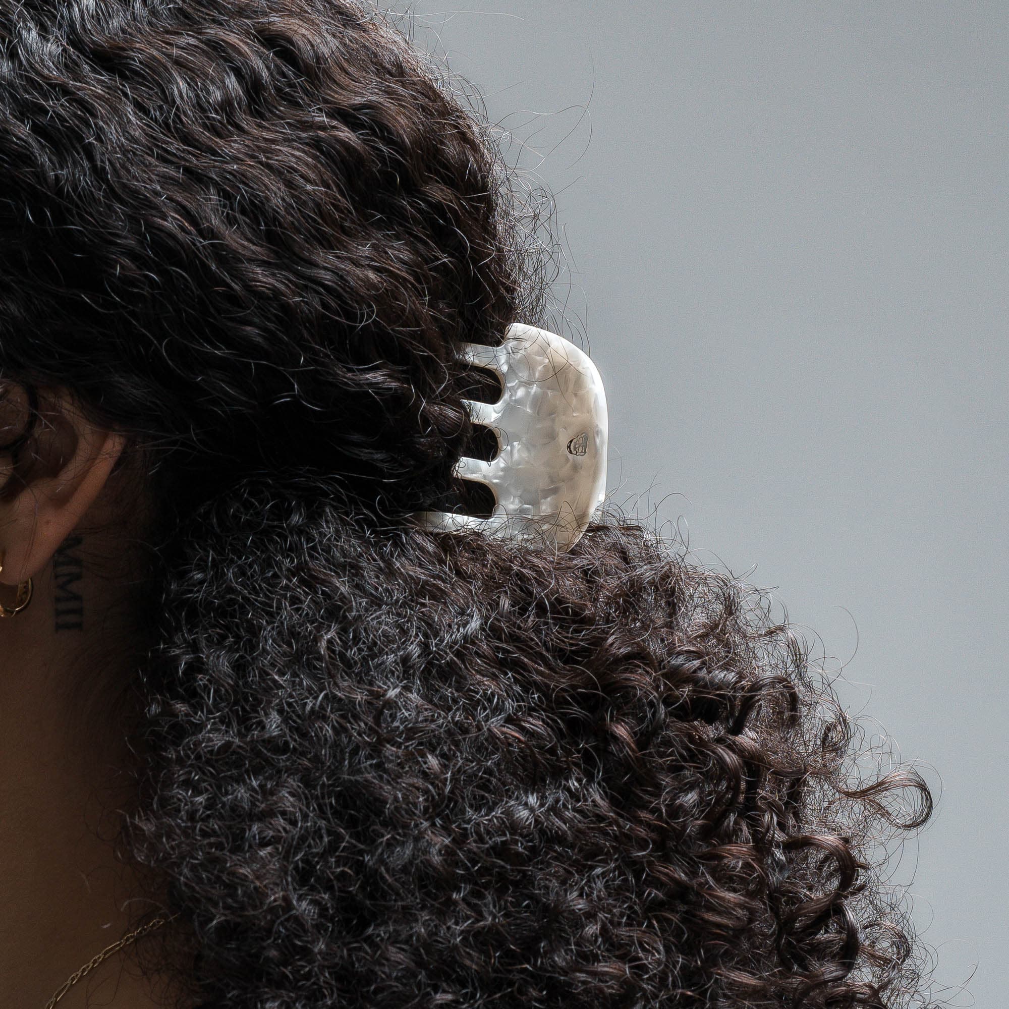model wearing Small Claw Clip - Ivory curly brown hair