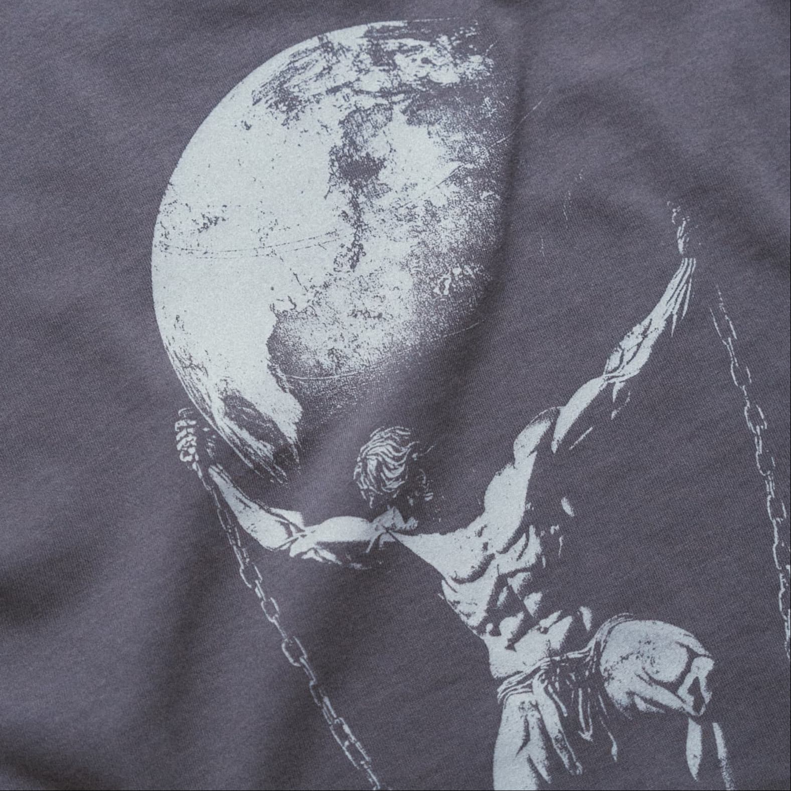 Detail shot of the back graphic on the As Above So Below Graphic Tee in amethyst smoke, highlighting the Atlas design.