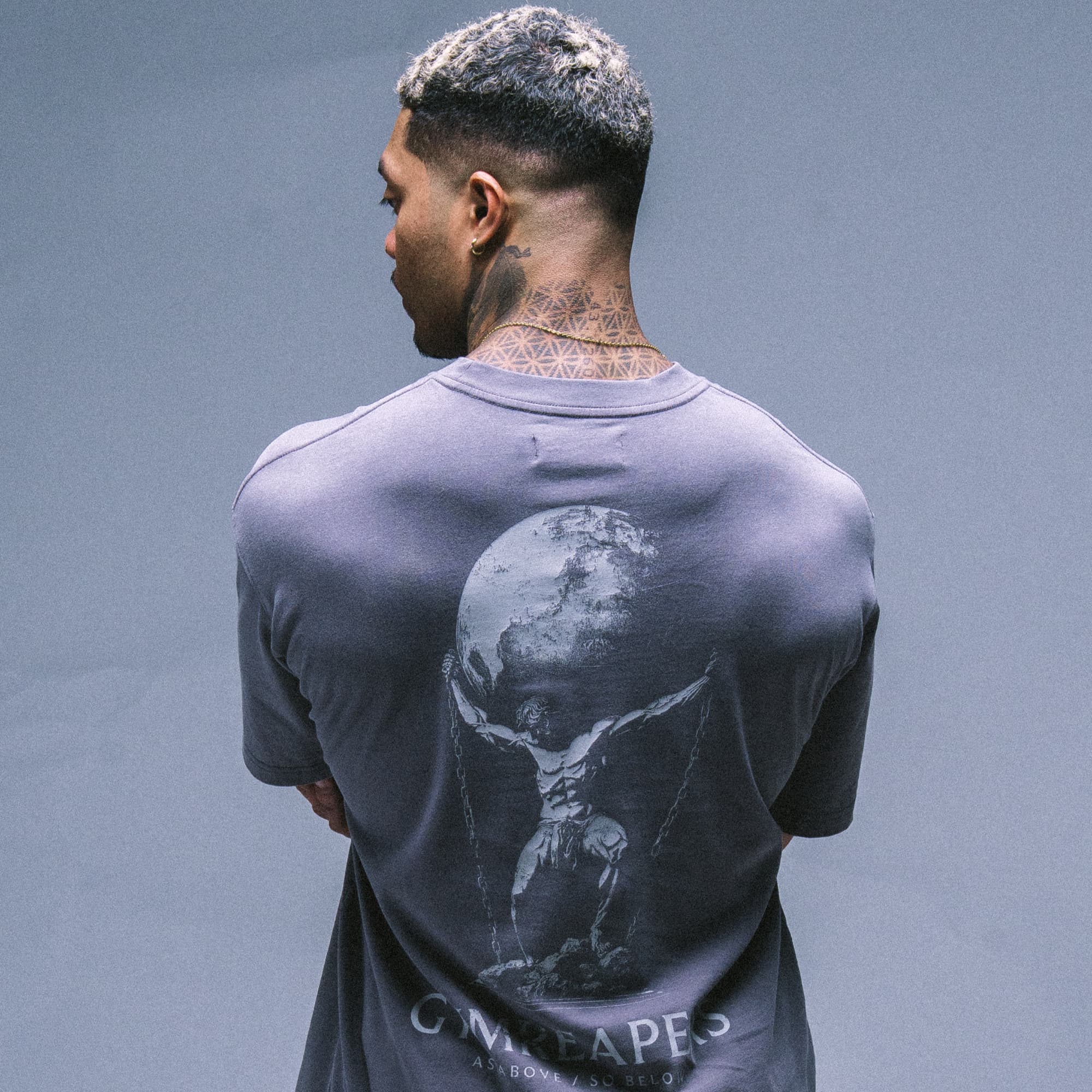 Athlete wearing the As Above So Below Graphic Tee in Amethyst Smoke, showing the full back graphic design.