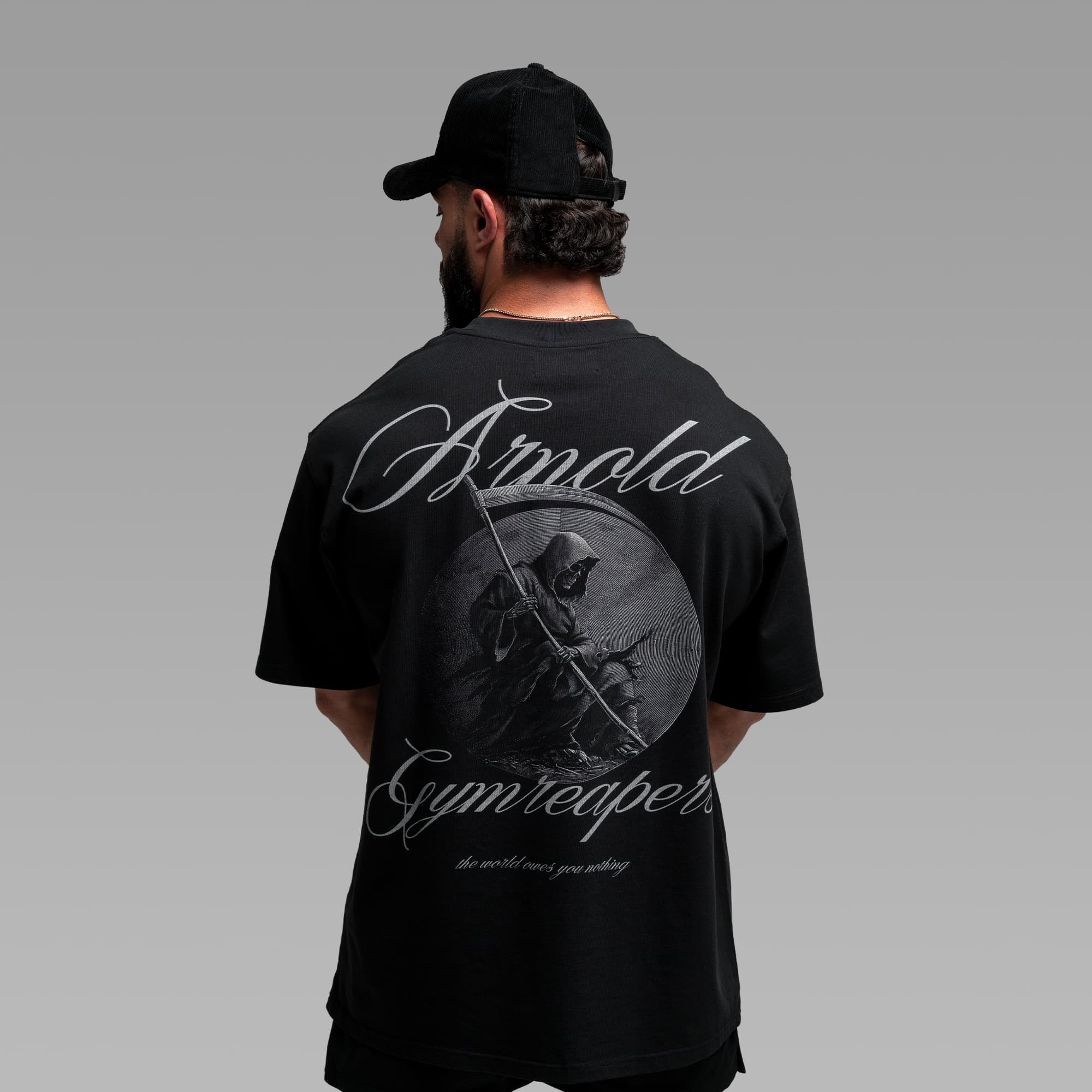 Athlete wearing the Midnight Reaper Tee half body shot back side