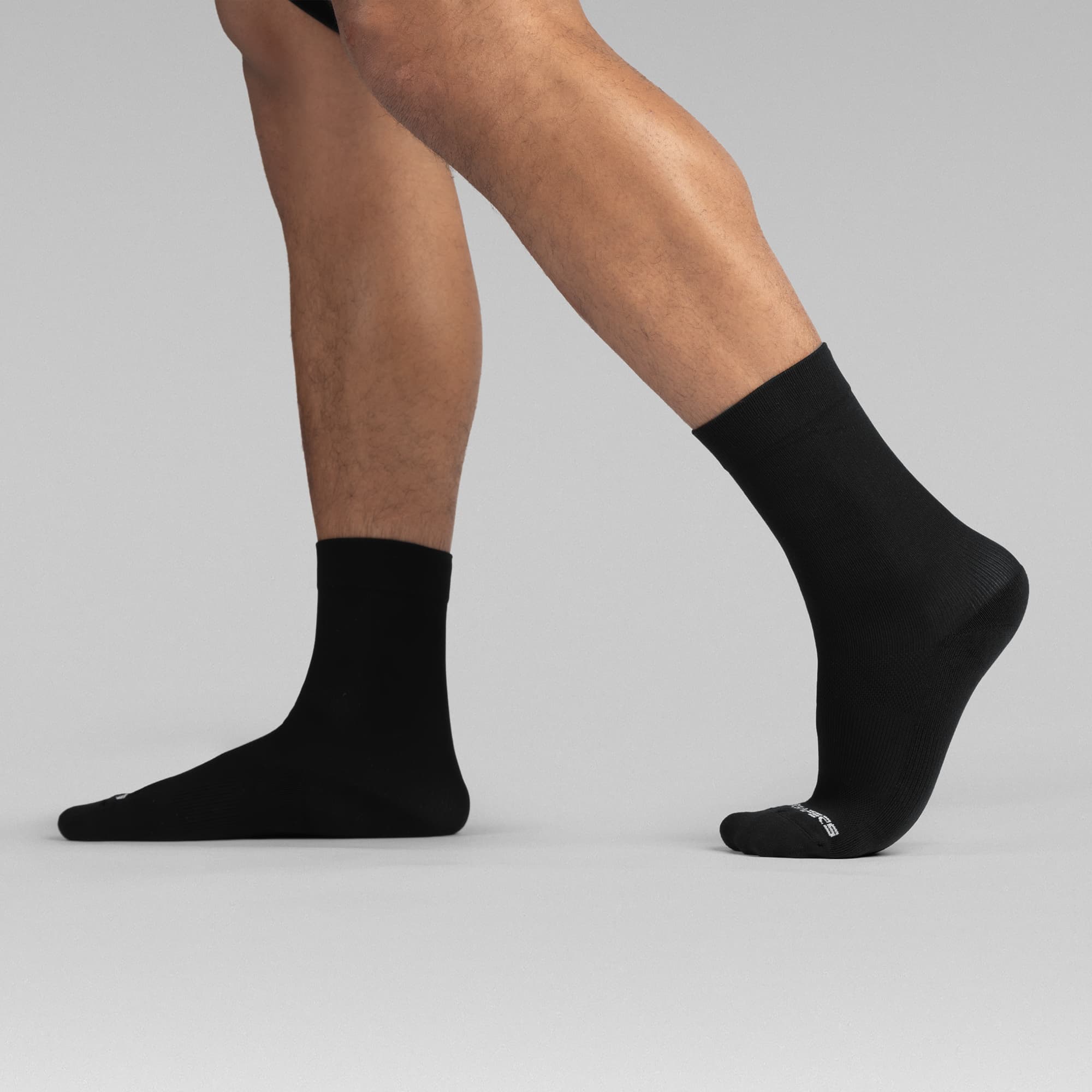 Athlete wearing the Black Stryda™ Crew Run Socks side view