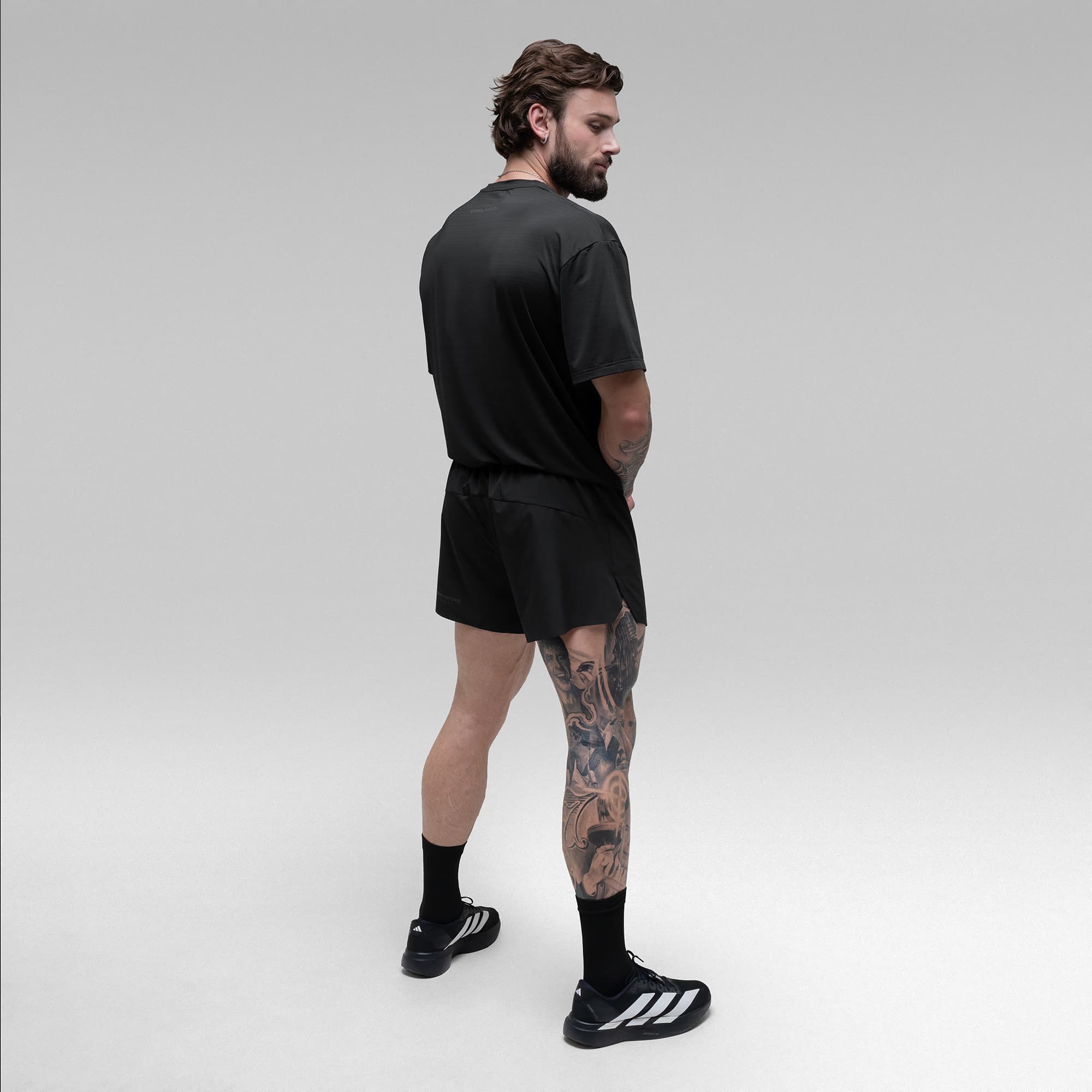 Athlete wearing the Ghost Oversized Tee full body shot back view