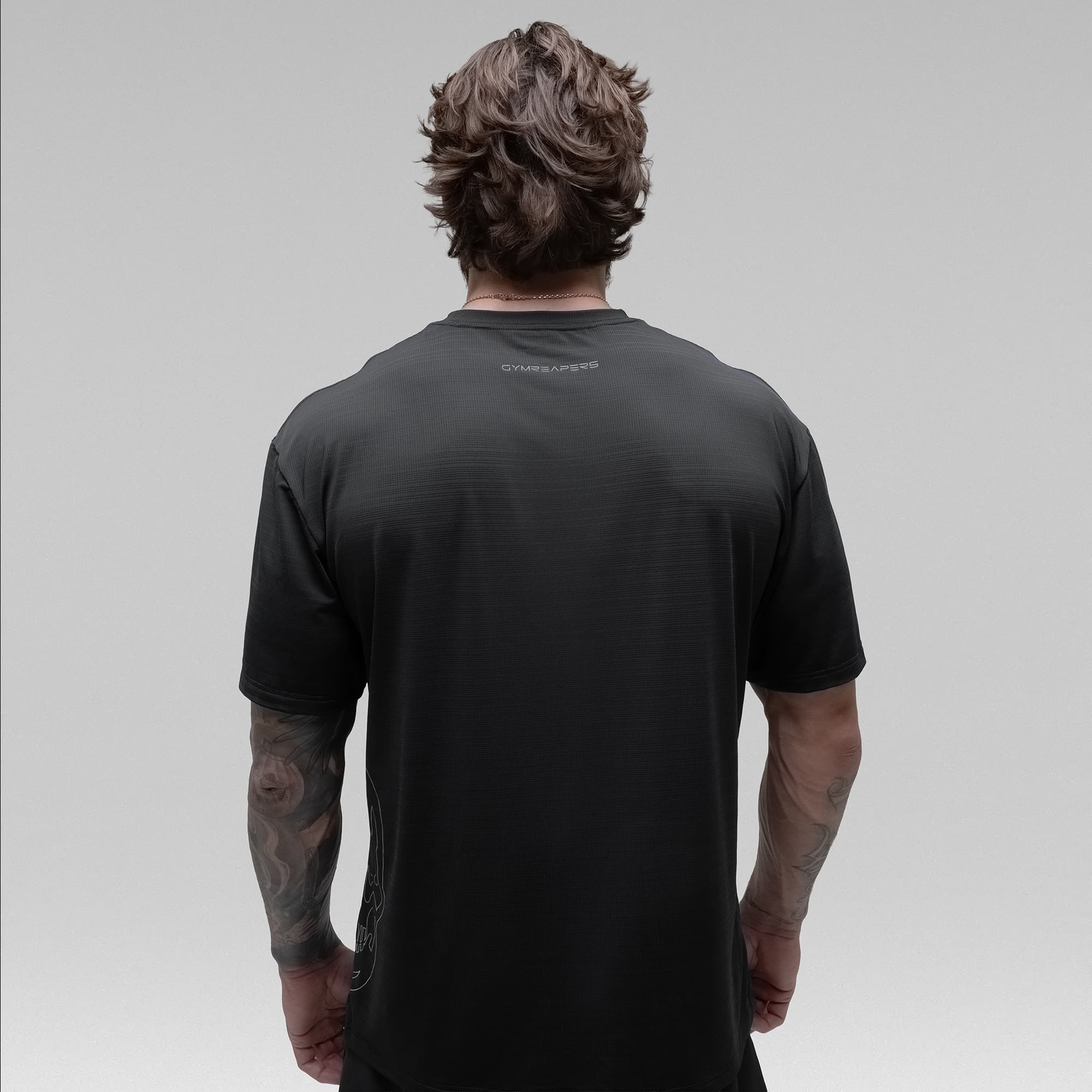 Athlete wearing the Ghost Oversized Tee half body shot back view