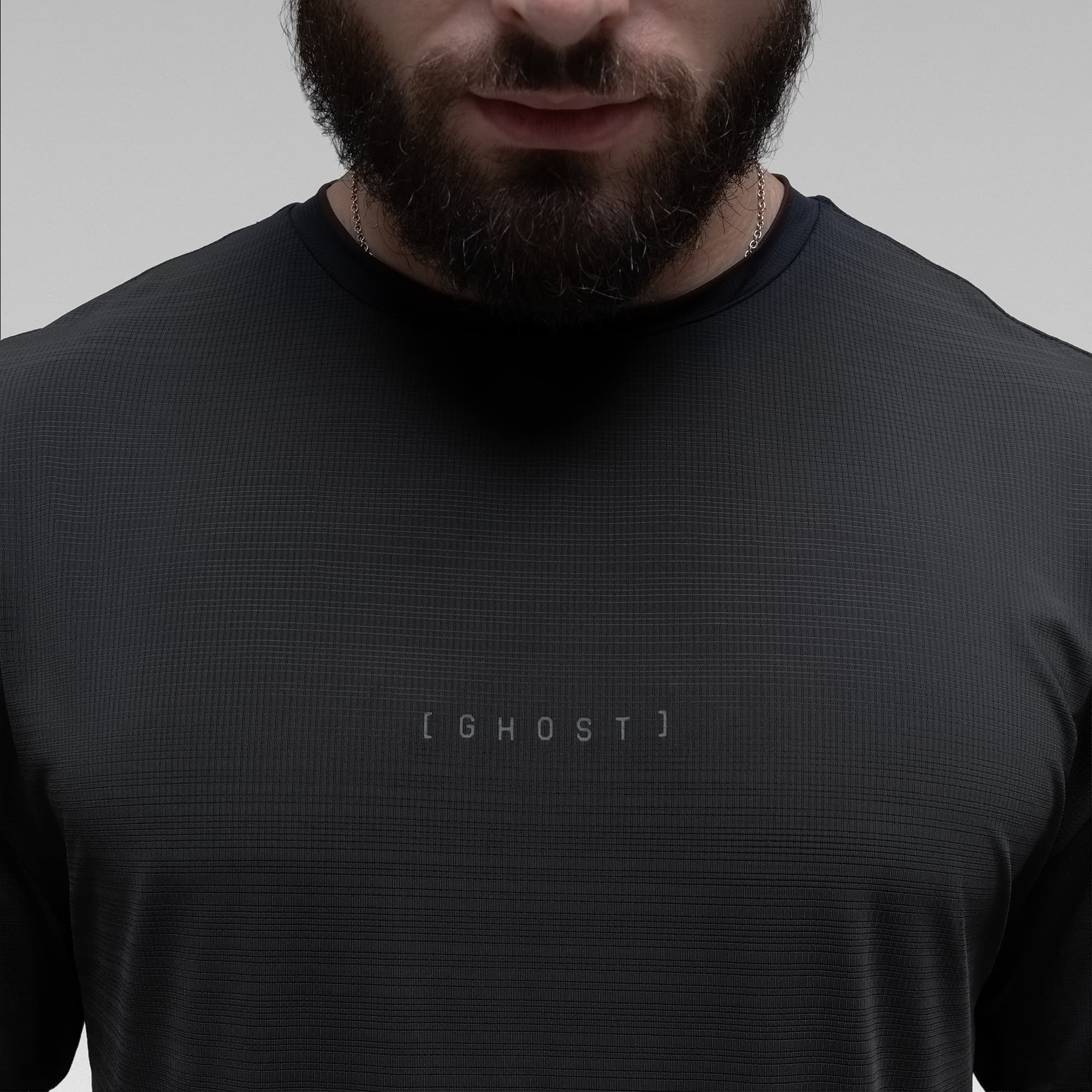 Athlete wearing the Ghost Oversized Tee close up shot of chest logo