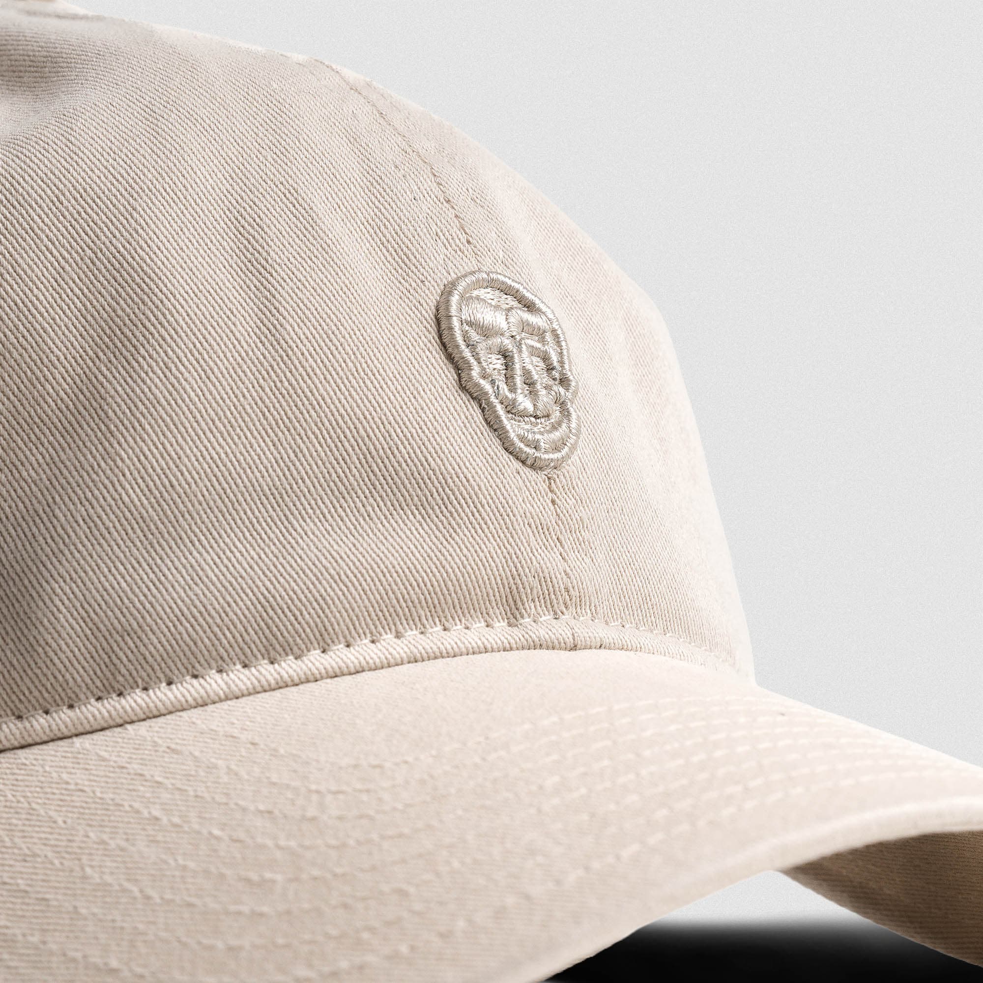 Washed 6-Panel Dad Hat - Tan close up shot of logo