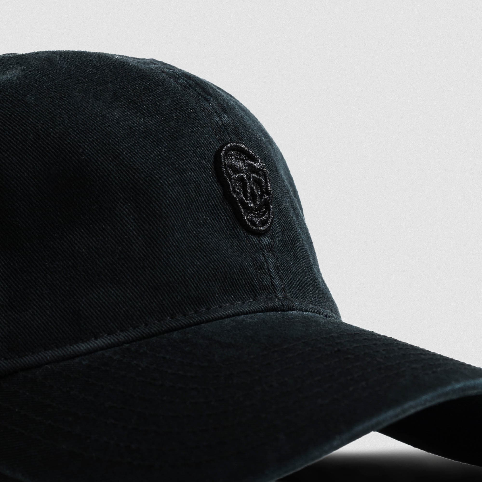 Washed 6-Panel Dad Hat - Black/Black close up shot of logo