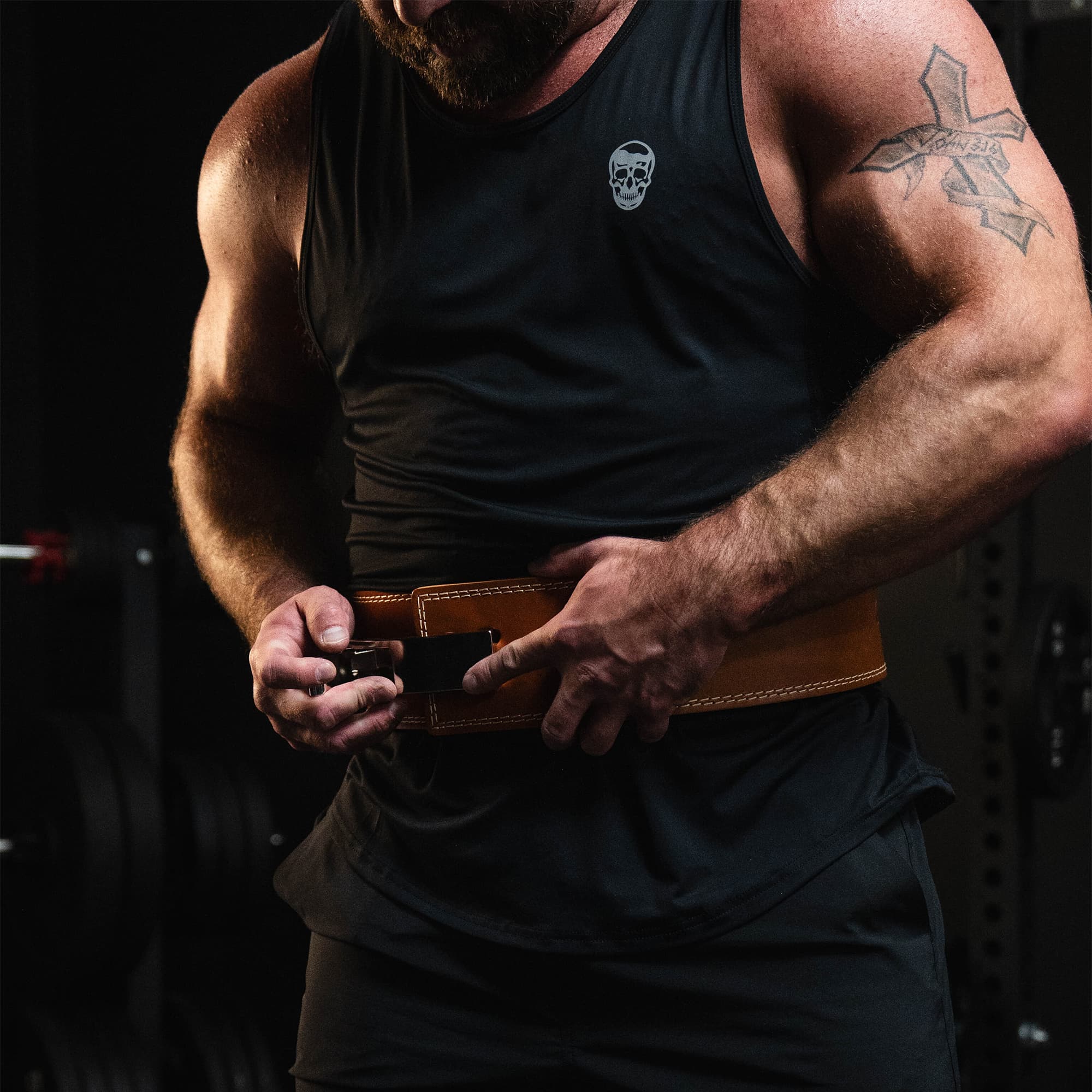 Studio shot of athlete engaging the heritage lever belt before a lift