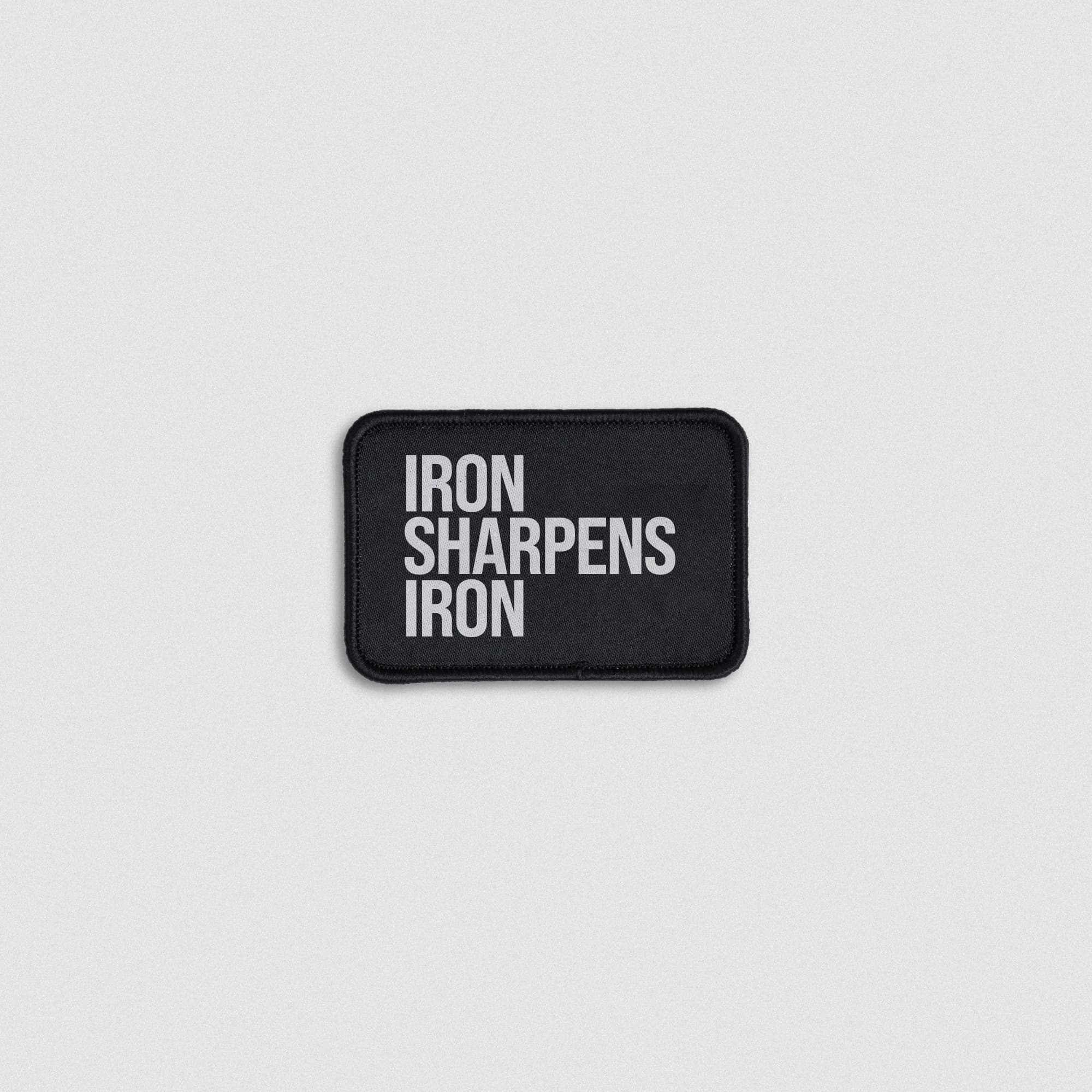 Iron sharpens iron fabric patch lay flat shot.