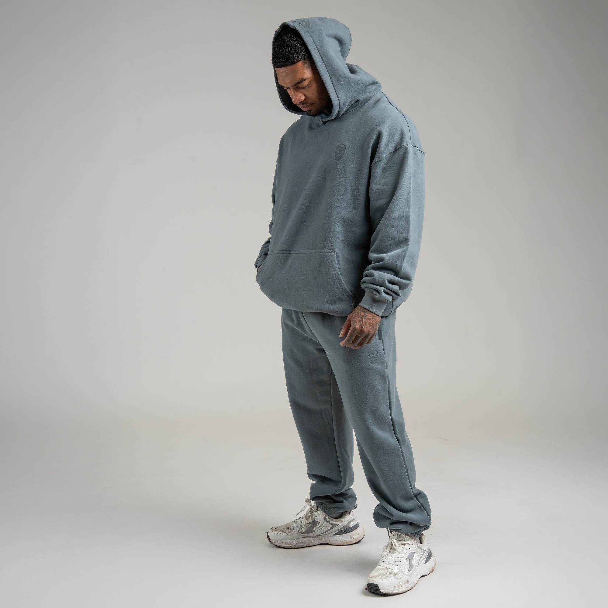 Athlete wearing Lake Heavyweight Jogger full body shot with hood on