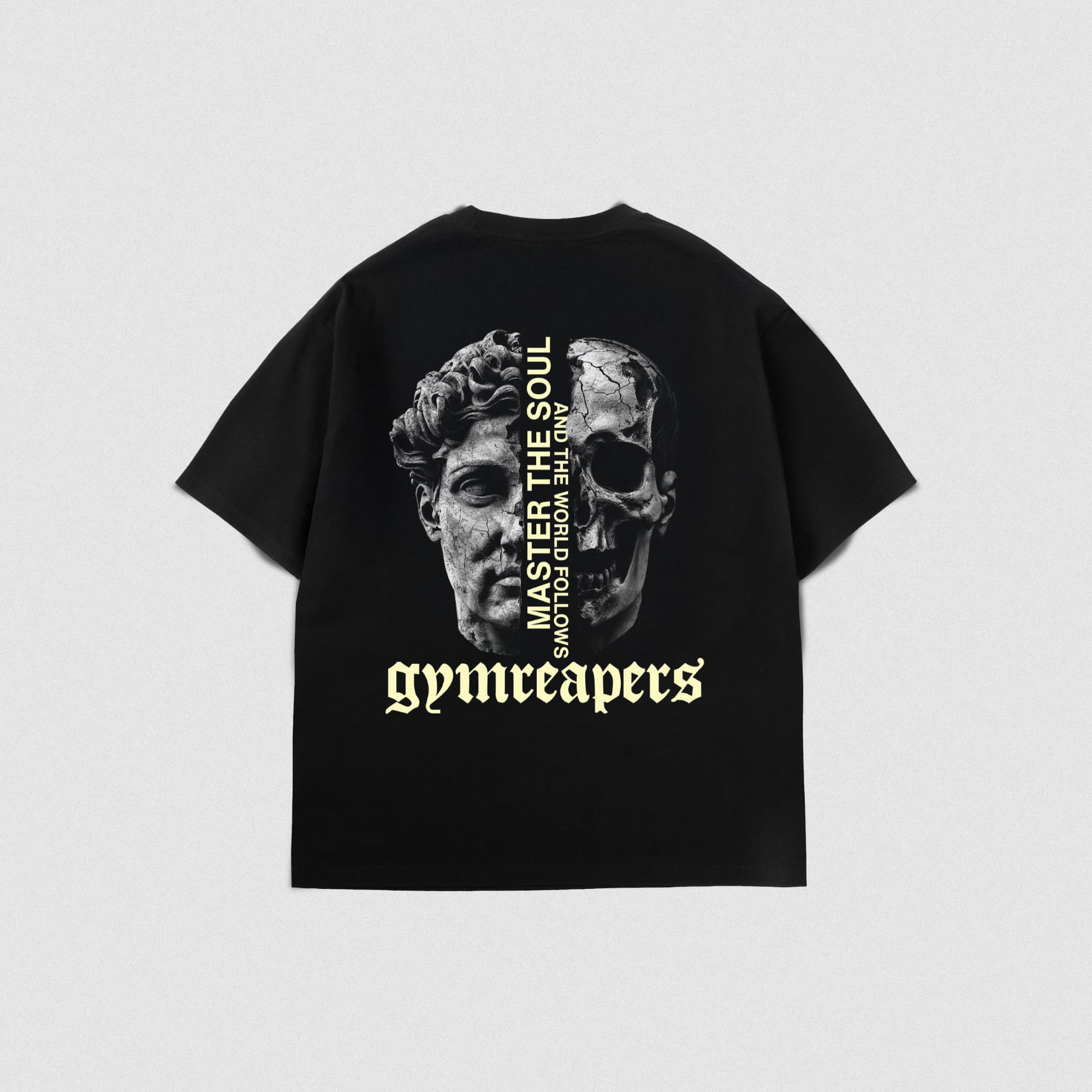 Back view of the Master The Soul Graphic Tee showcasing a split face statue and skull graphic with bold Gymreapers logo and vertical mantra