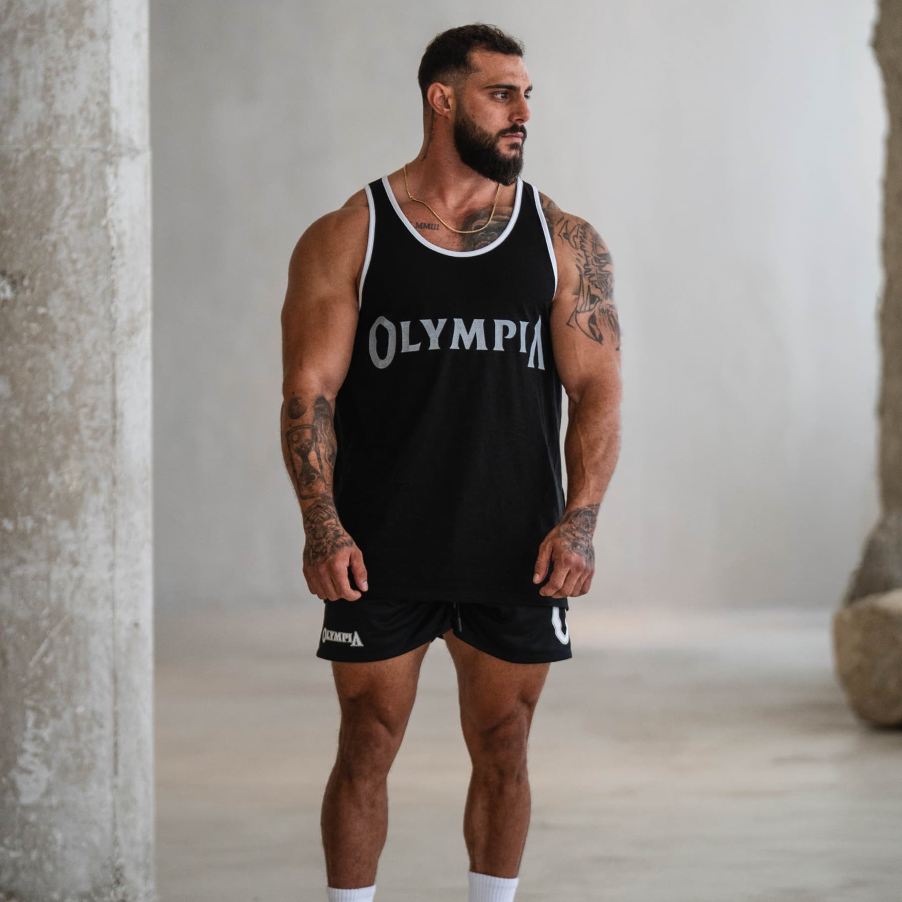 Full front view of the Bound Edge Classic Olympia Stringer on model paired with black Olympia shorts.