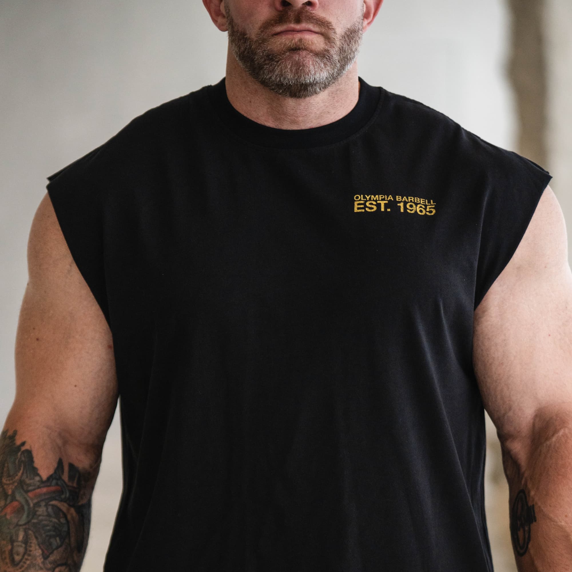 Close-up of the front chest graphic on the Olympia Crest Cut Off
