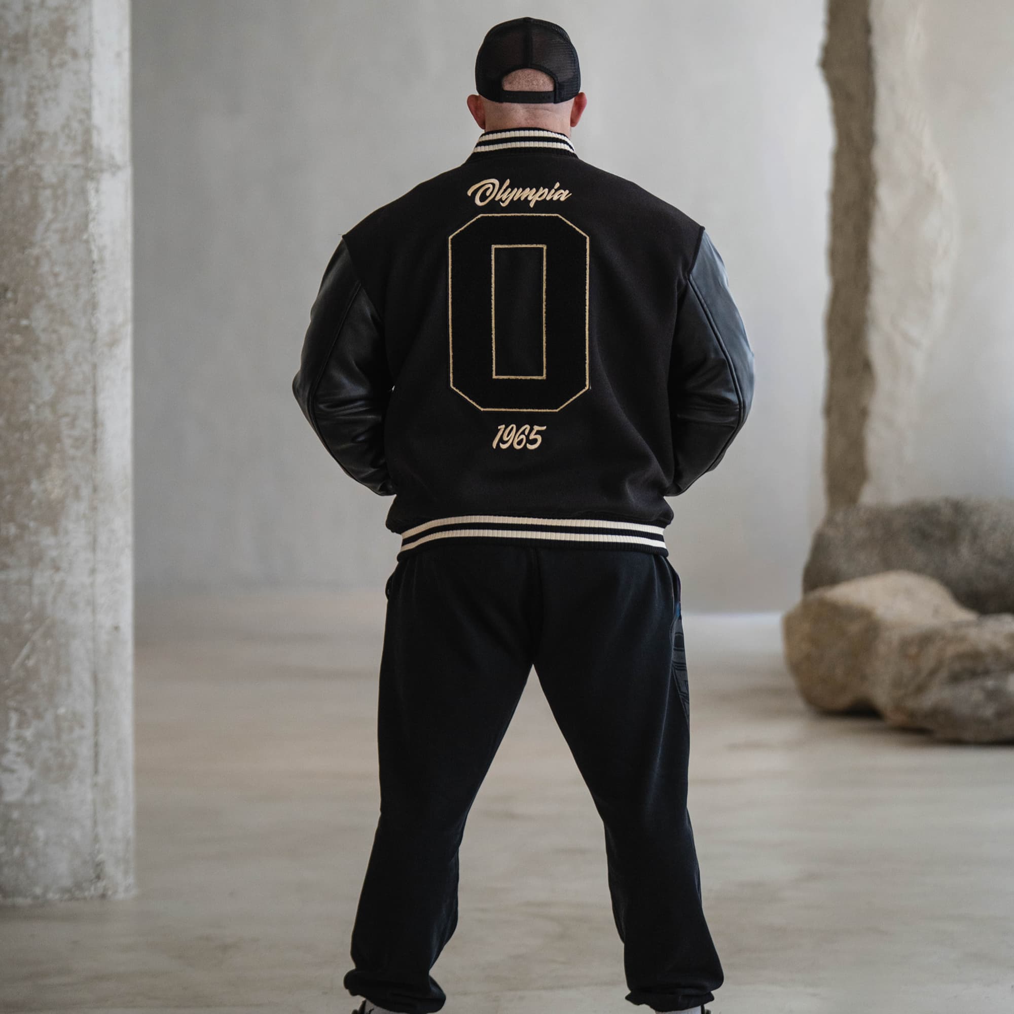Olympia O Varsity Jacket on athlete full body shot back view