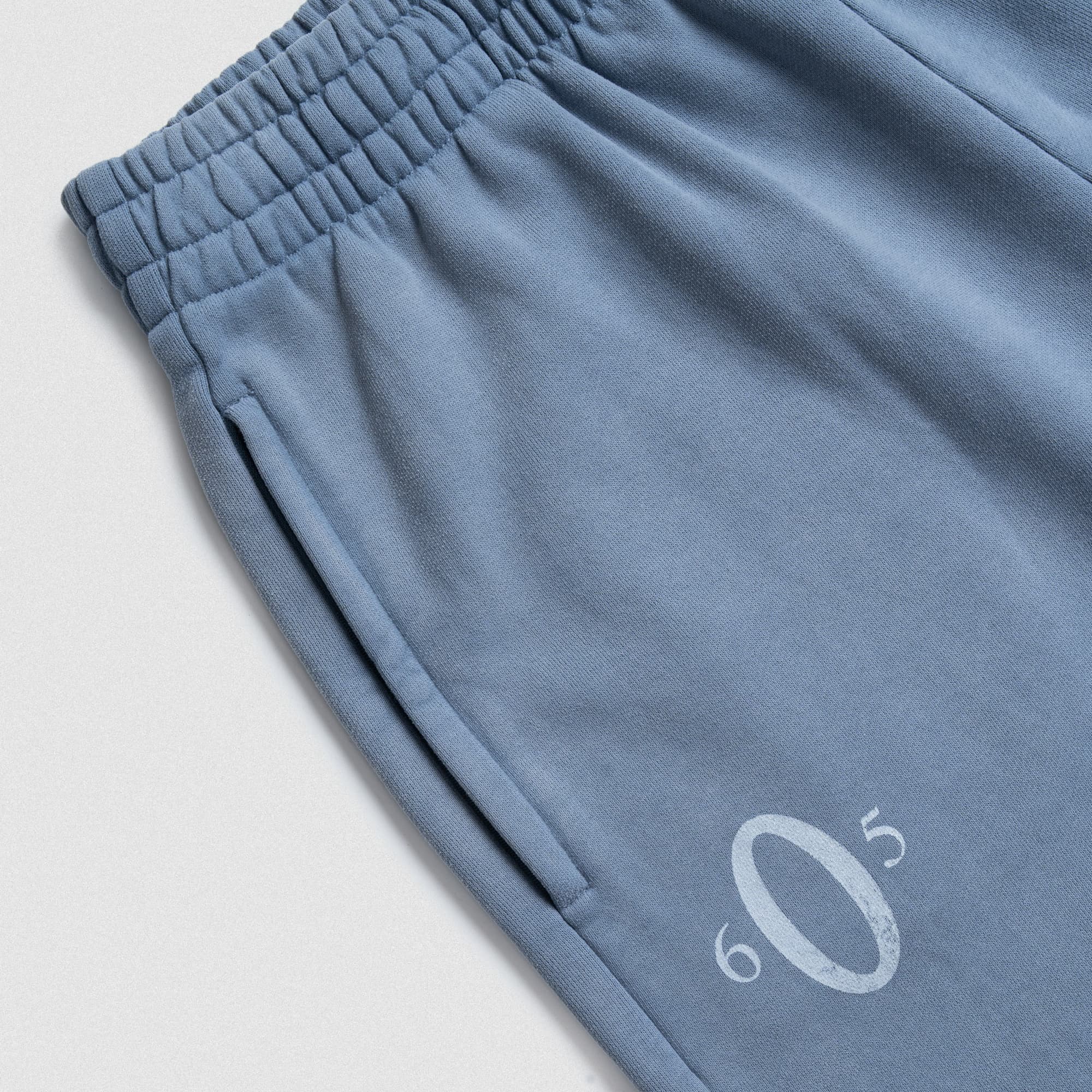 Close-up of waistband and pocket with Olympia logo