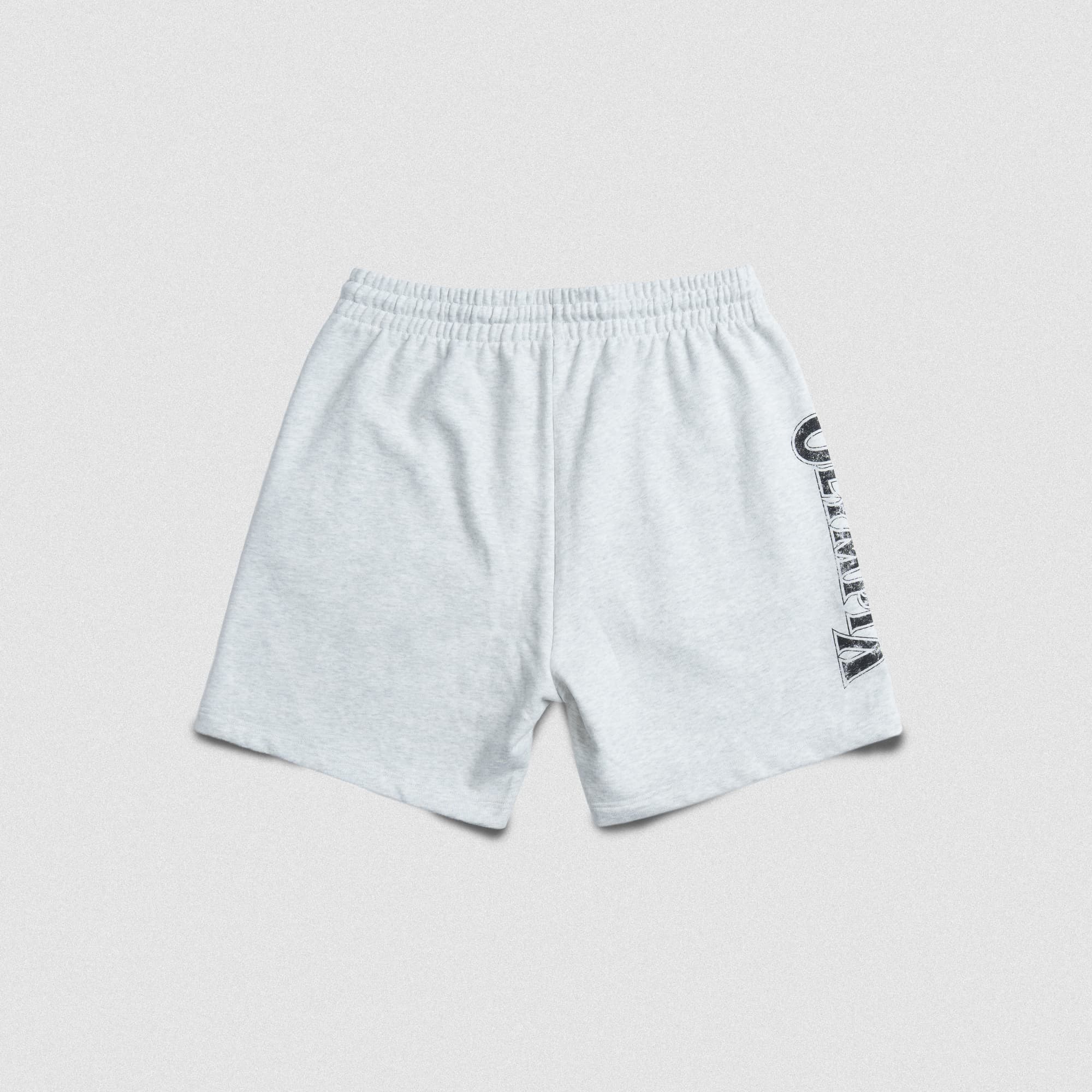 Flat lay back view of the Olympia Sweat Short in light grey, showing a plain back with vertical “Olympia” graphic wrapping from the side.