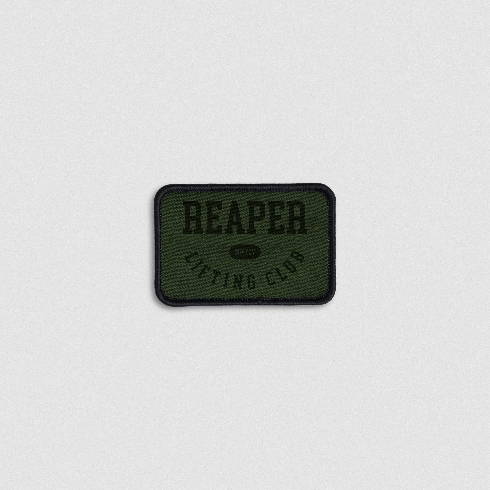 Embroidered patch with Reaper Lifting Club text in black on a green fabric background