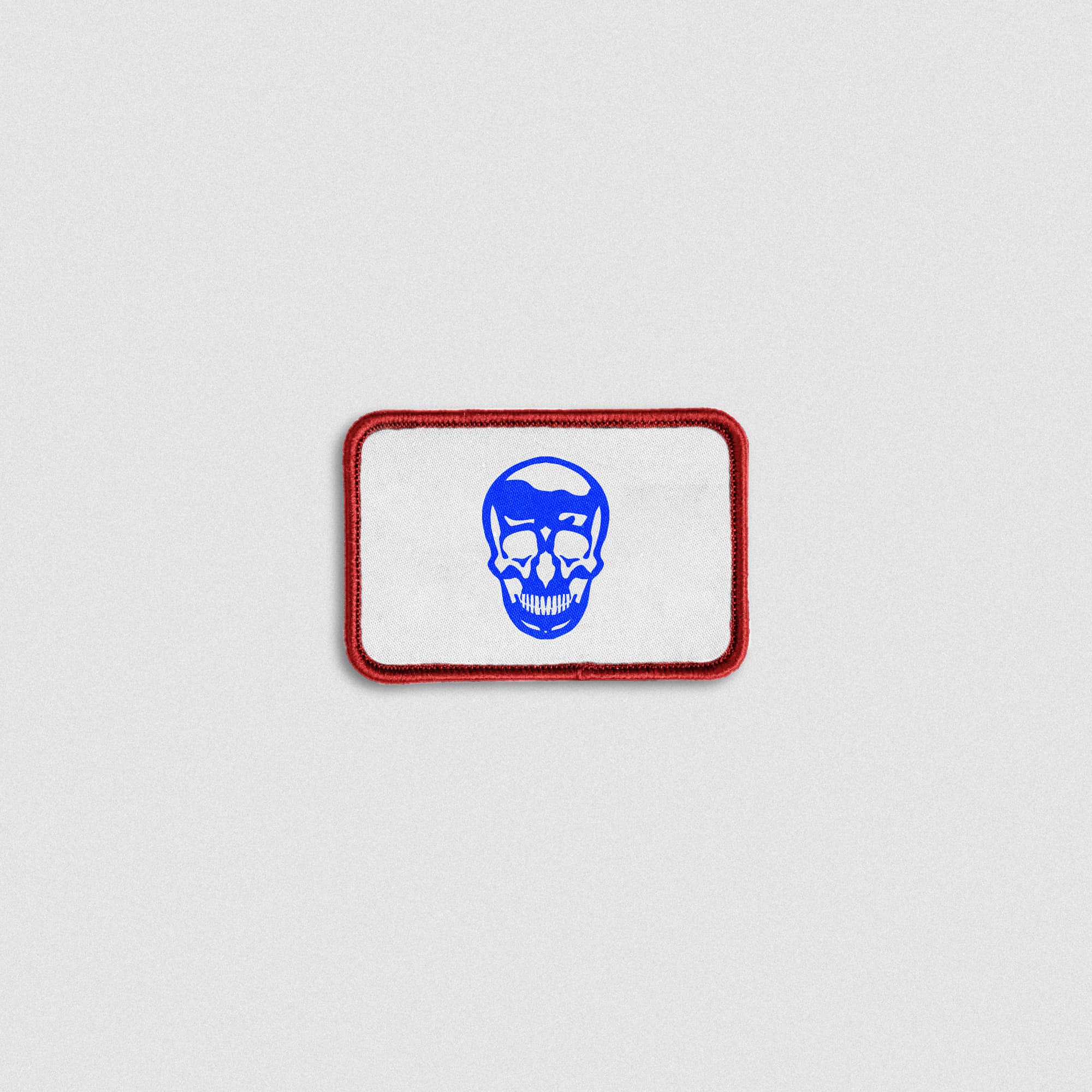 USA colorway skull patch with red border, white background, and blue skull graphic