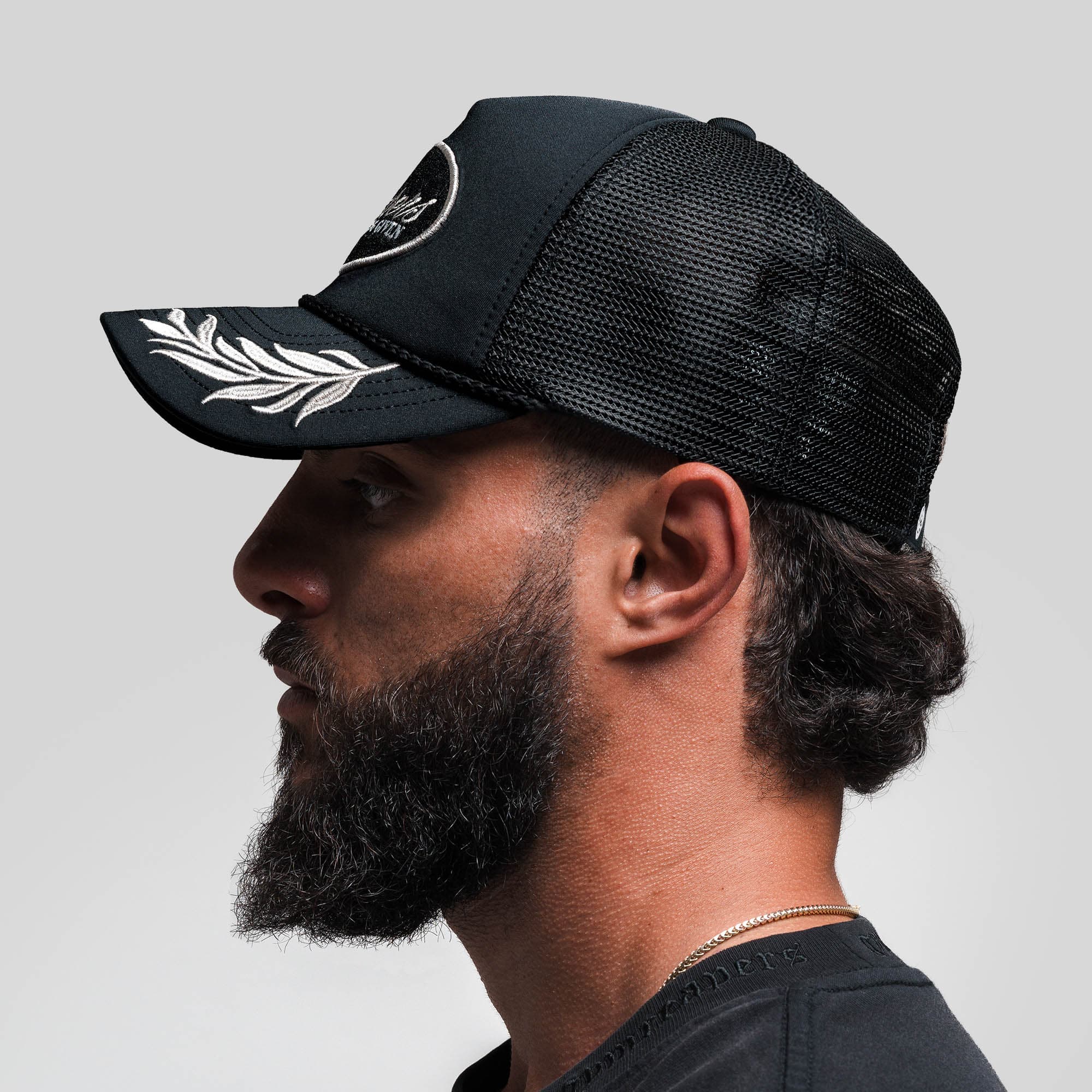 Athlete wearing Laurel Foam Trucker Hat - Black side view