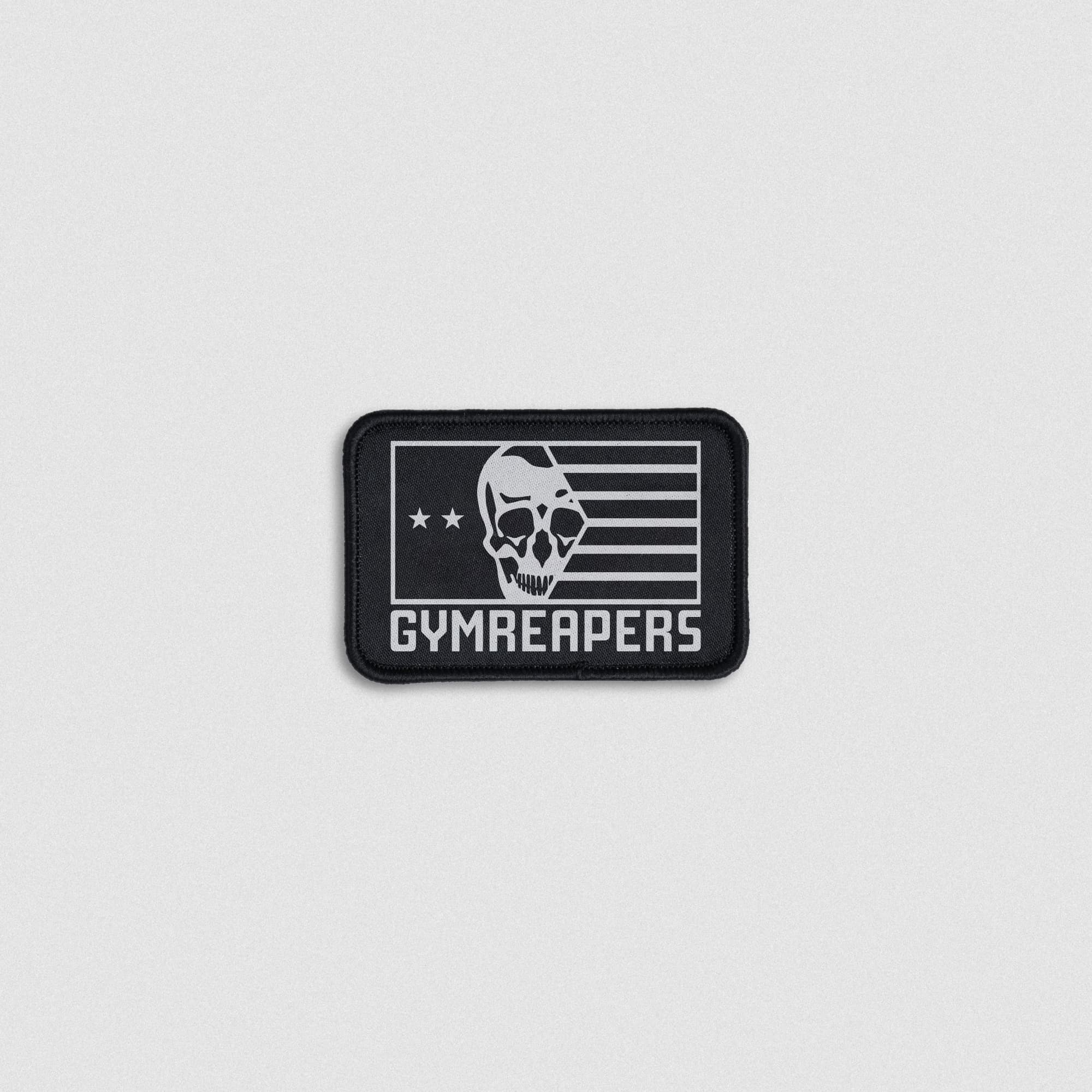 Black patch featuring a skull, two stars, horizontal stripes, and bold Gymreapers text