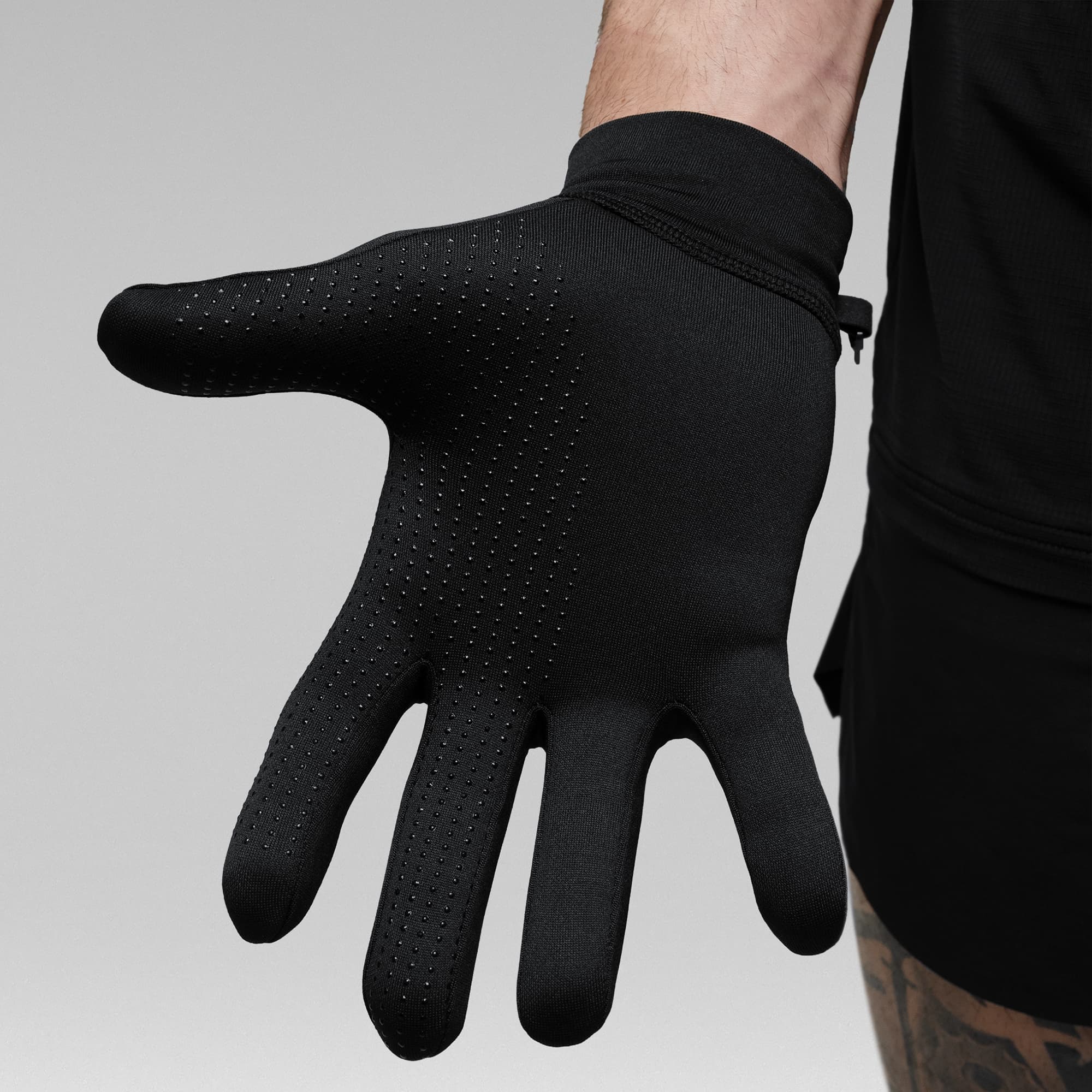 Model wearing the Black Stryda™ Run Gloves showcasing the silicone grip