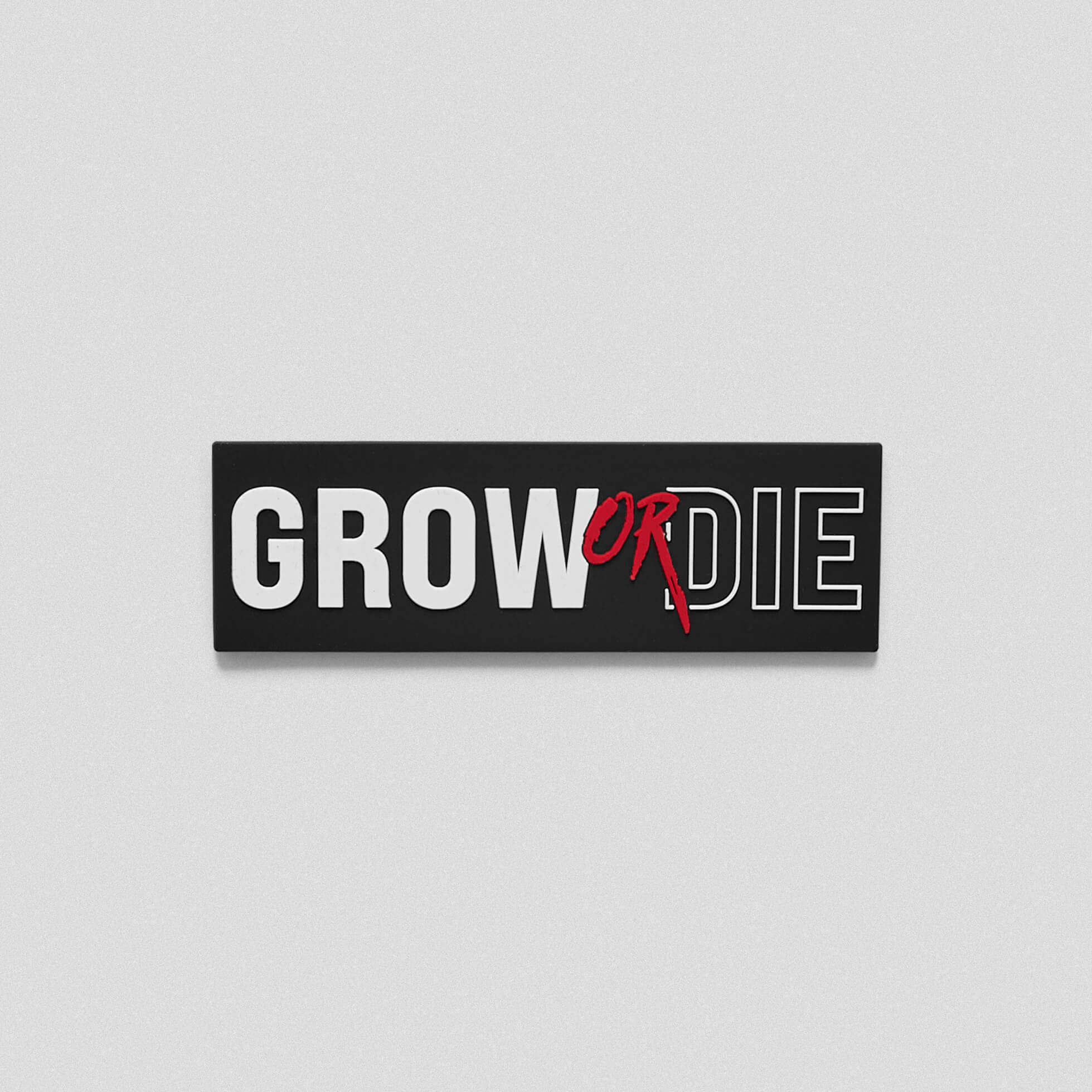 A black white patch with a little red that says Grow Or Die across the middle.