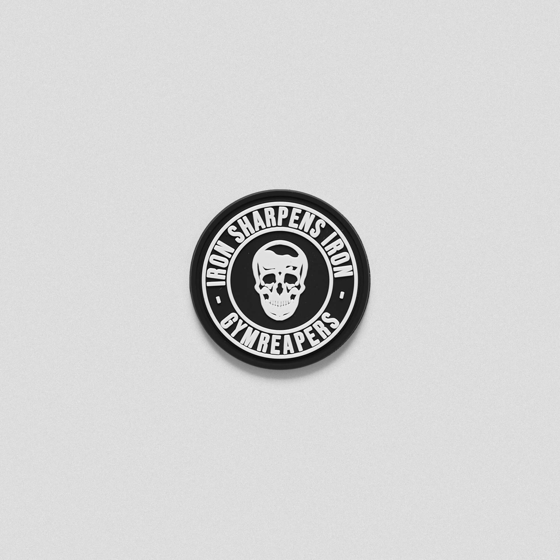 A black white iron sharpens iron patch with skull in the middle.