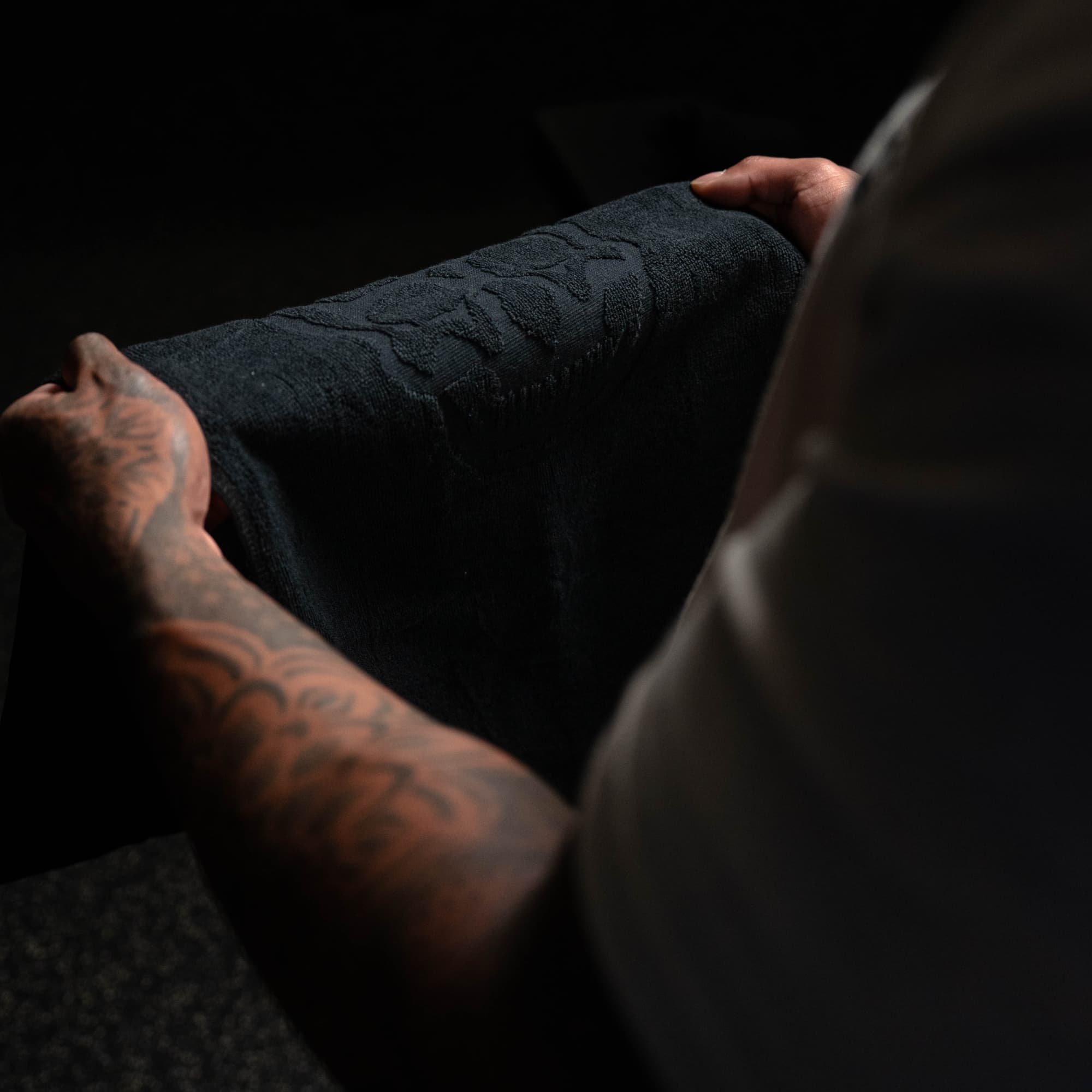 athlete holding skull gym towel