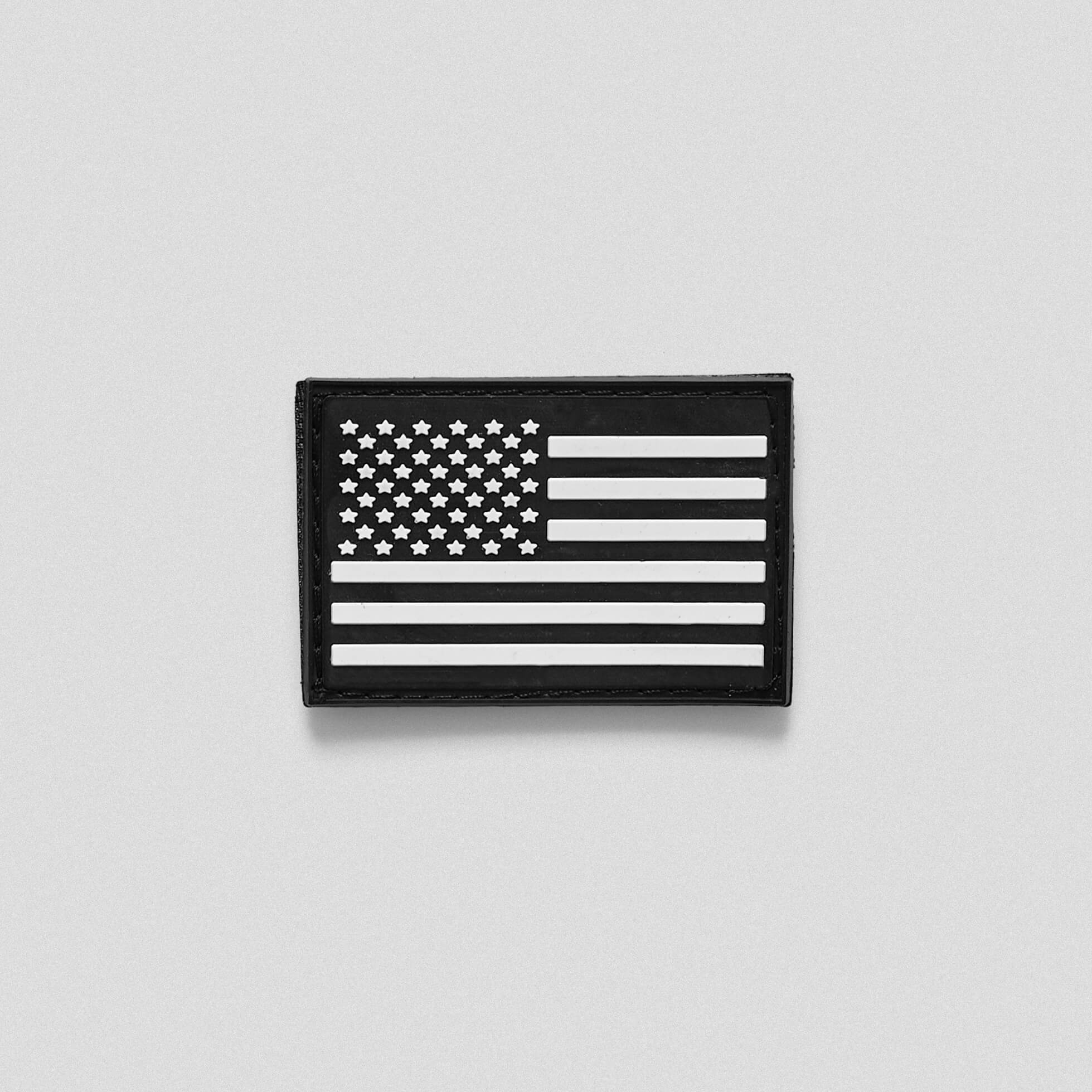 A black and white patch with the USA flag in the center.